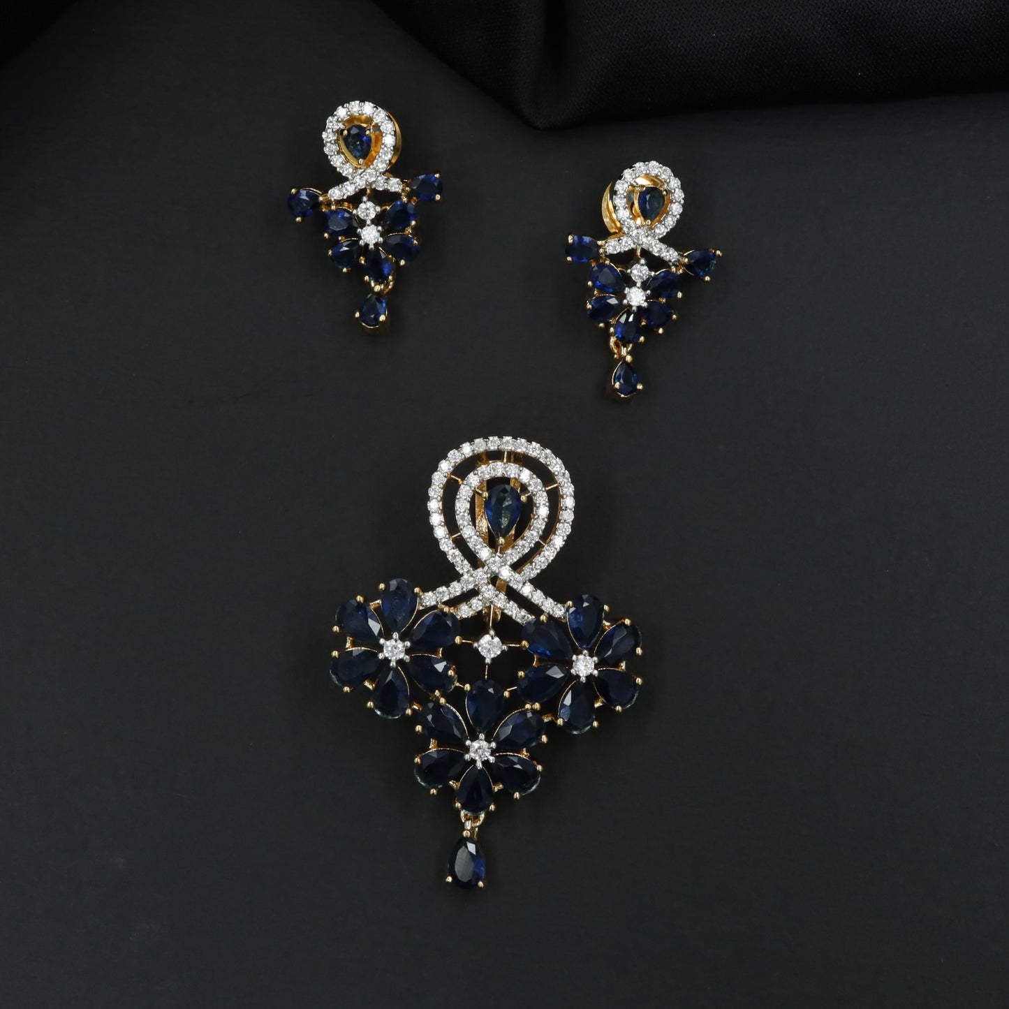 Decorative pendant set with floral craftsmanship and looped centerpiece