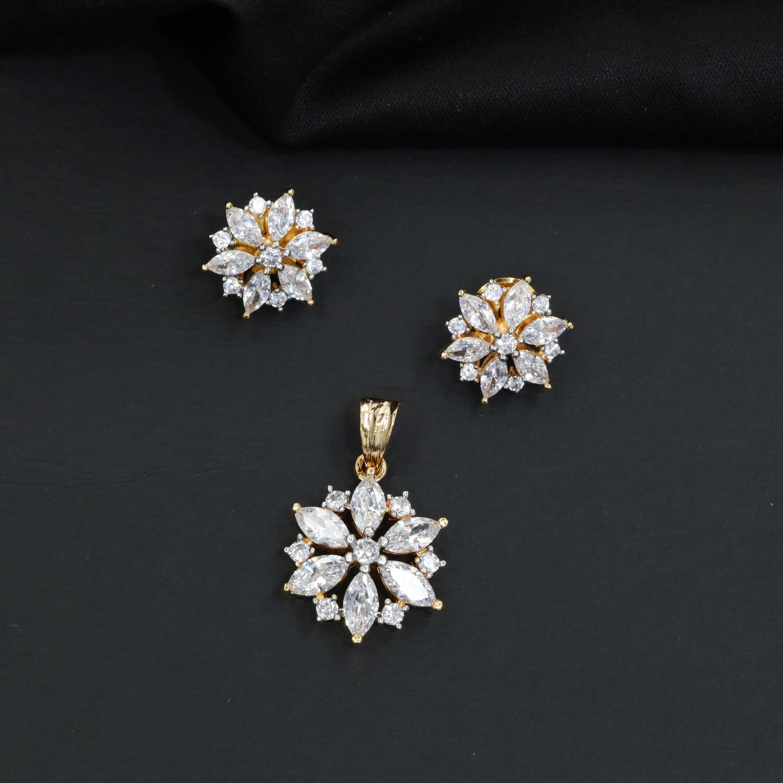 Floral bloom pendant set with marquise petal detailing and matching stud earrings