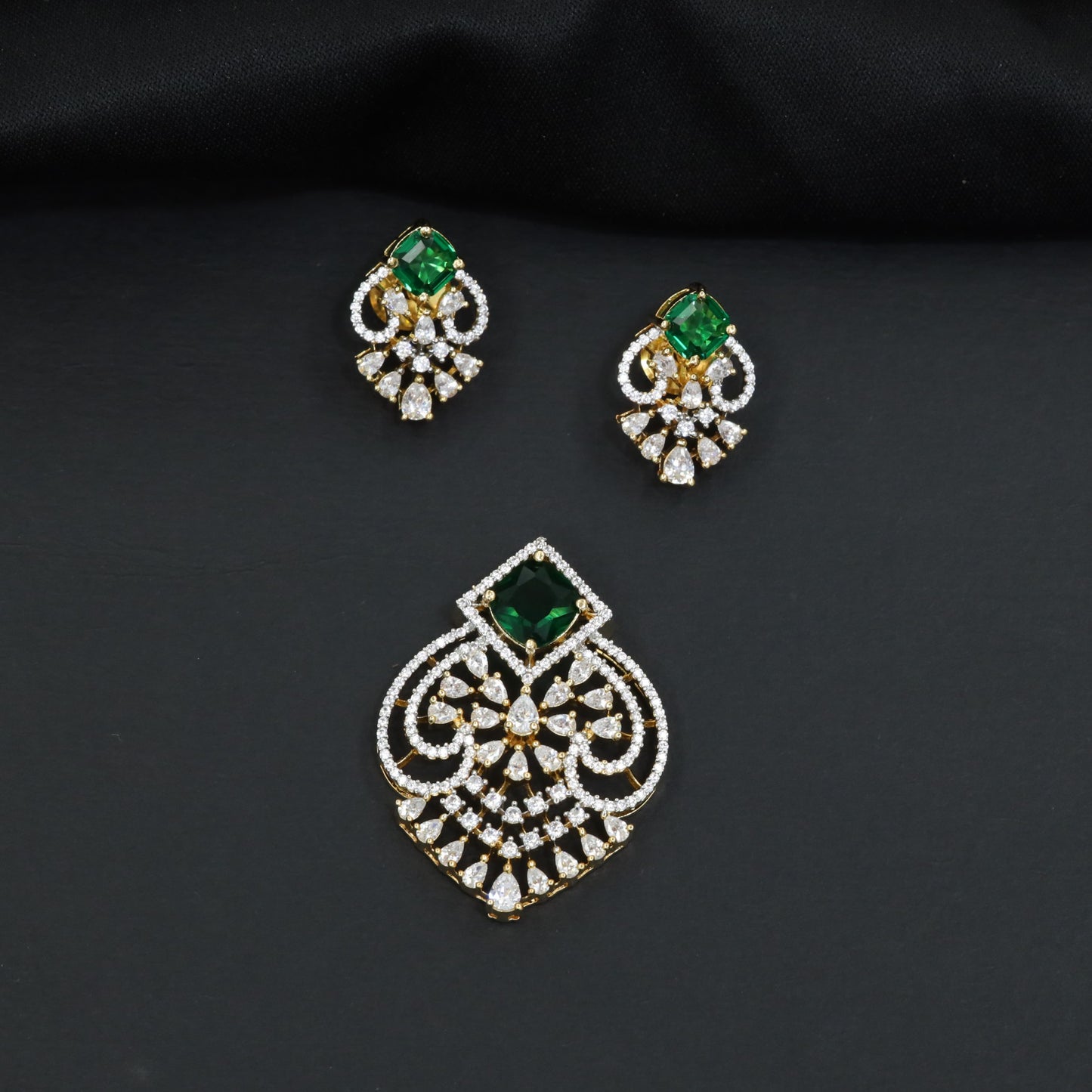 Handcrafted pendant set with floral filigree artistry and teardrop-shaped construction