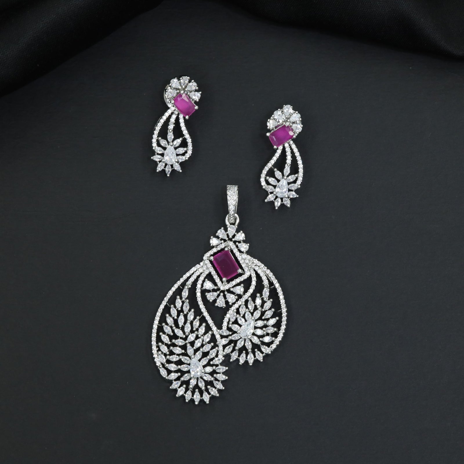 Artistic floral pendant set featuring twin leaf silhouettes and layered flower clusters