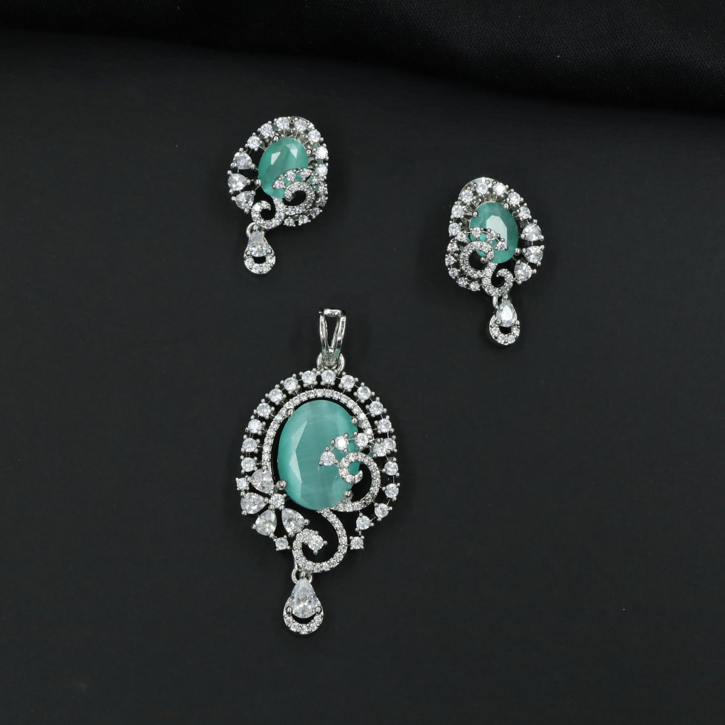 Statement floral pendant set showcasing curved vine craftsmanship and petal clusters