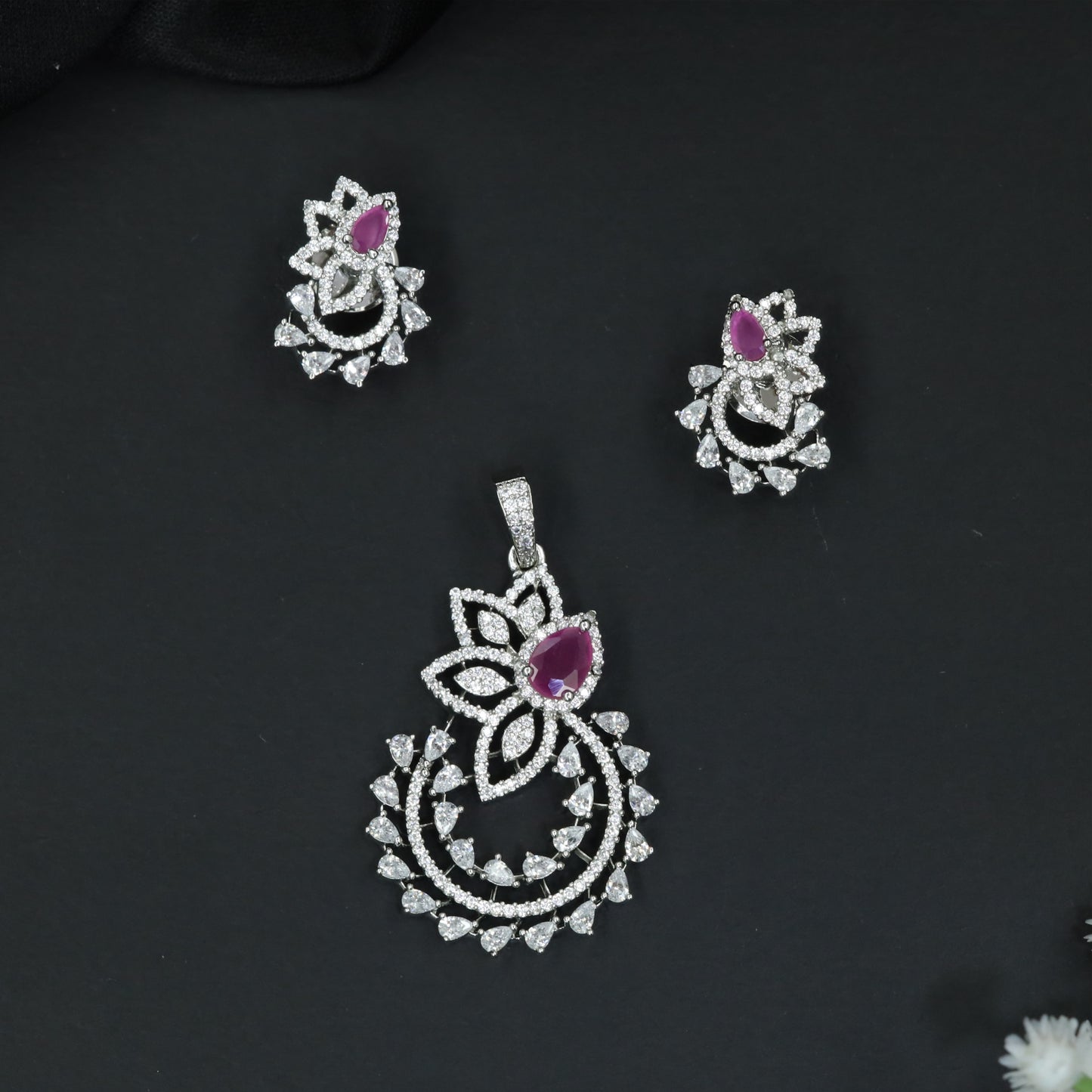 Designer pendant set showcasing a flower silhouette with cascading leaf accents