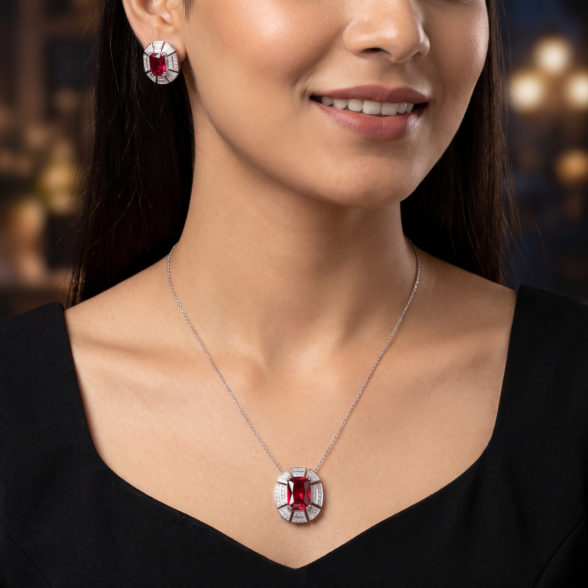 Contemporary pendant chain set with a structured medallion profile and matching stud earrings