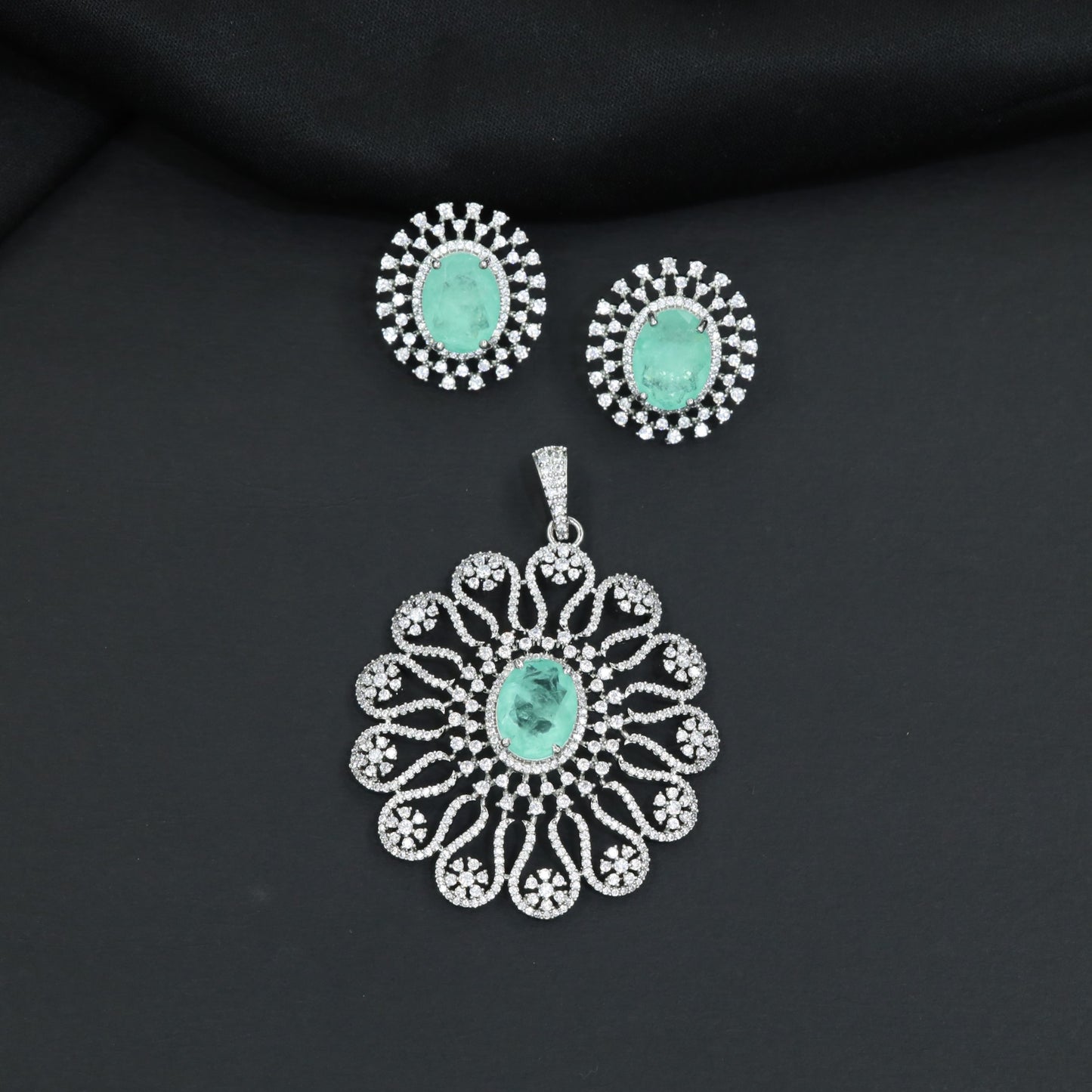 Grand flower pendant set featuring an oval centerpiece and scalloped petal arrangement