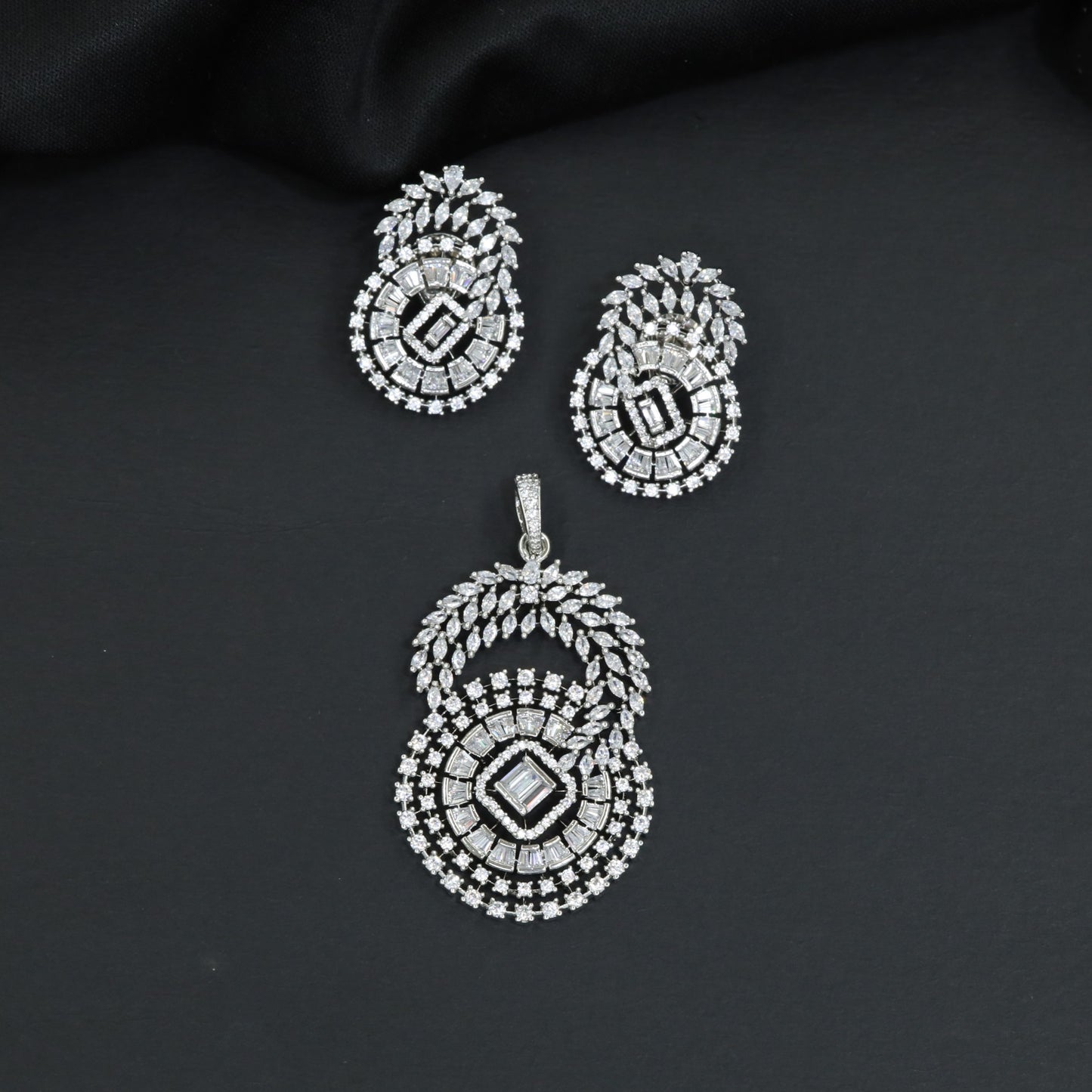 Floral halo pendant set with concentric circular detailing and matching earrings