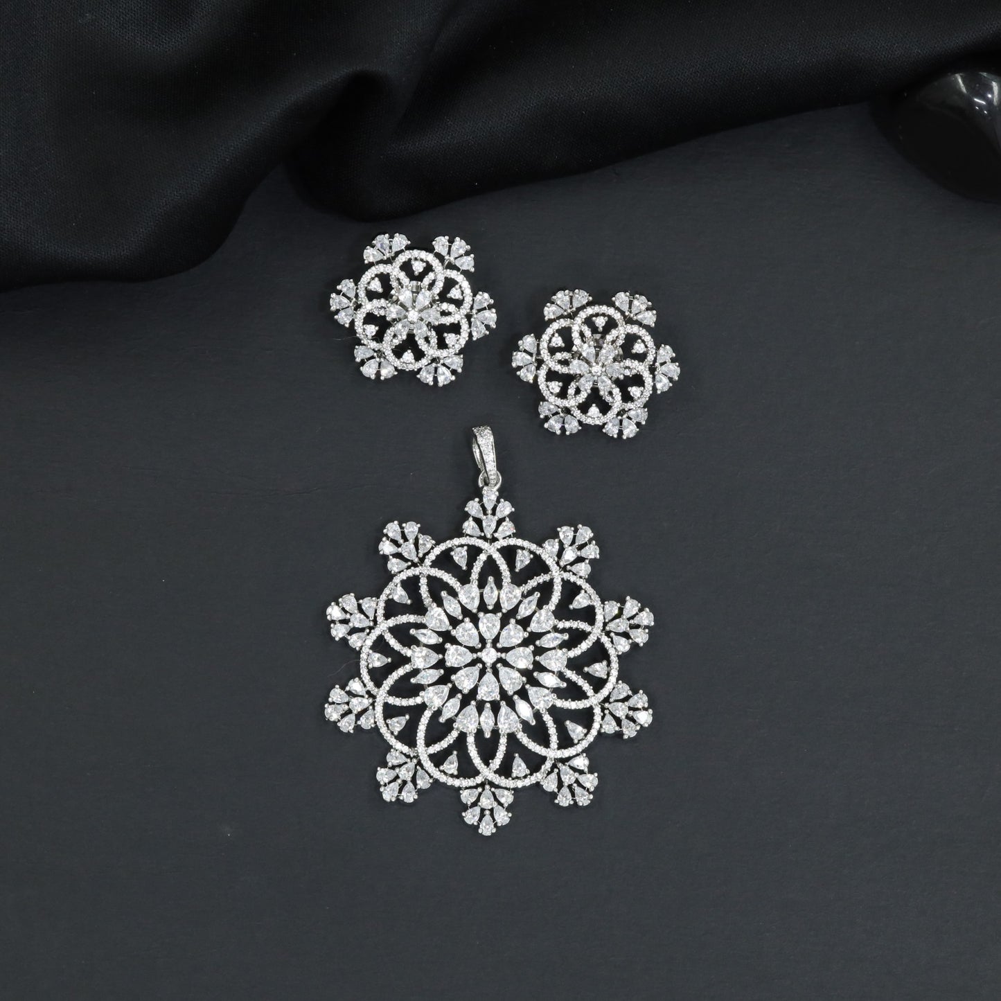 Mandala-inspired pendant set with intricate openwork pattern and floral accents