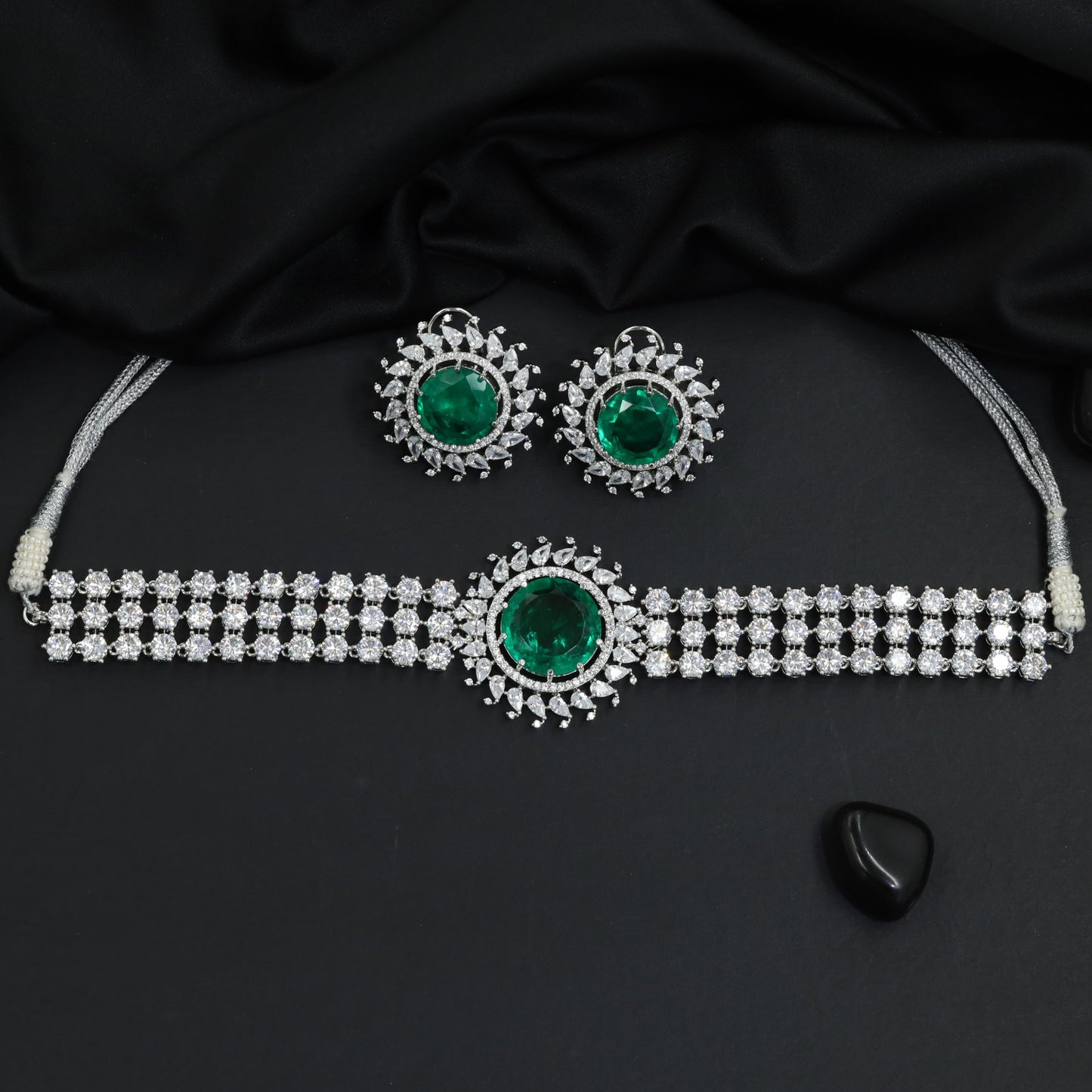 Traditional triple row tennis strand rhodium choker set with a starburst rosette center