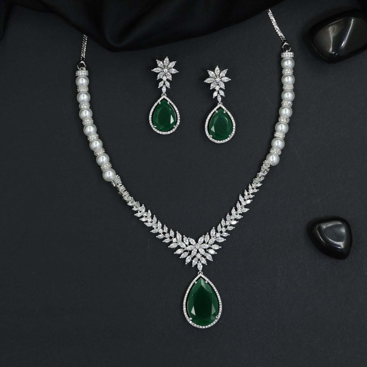 Traditional leaf branch linked rhodium necklace set with a suspended teardrop medallion