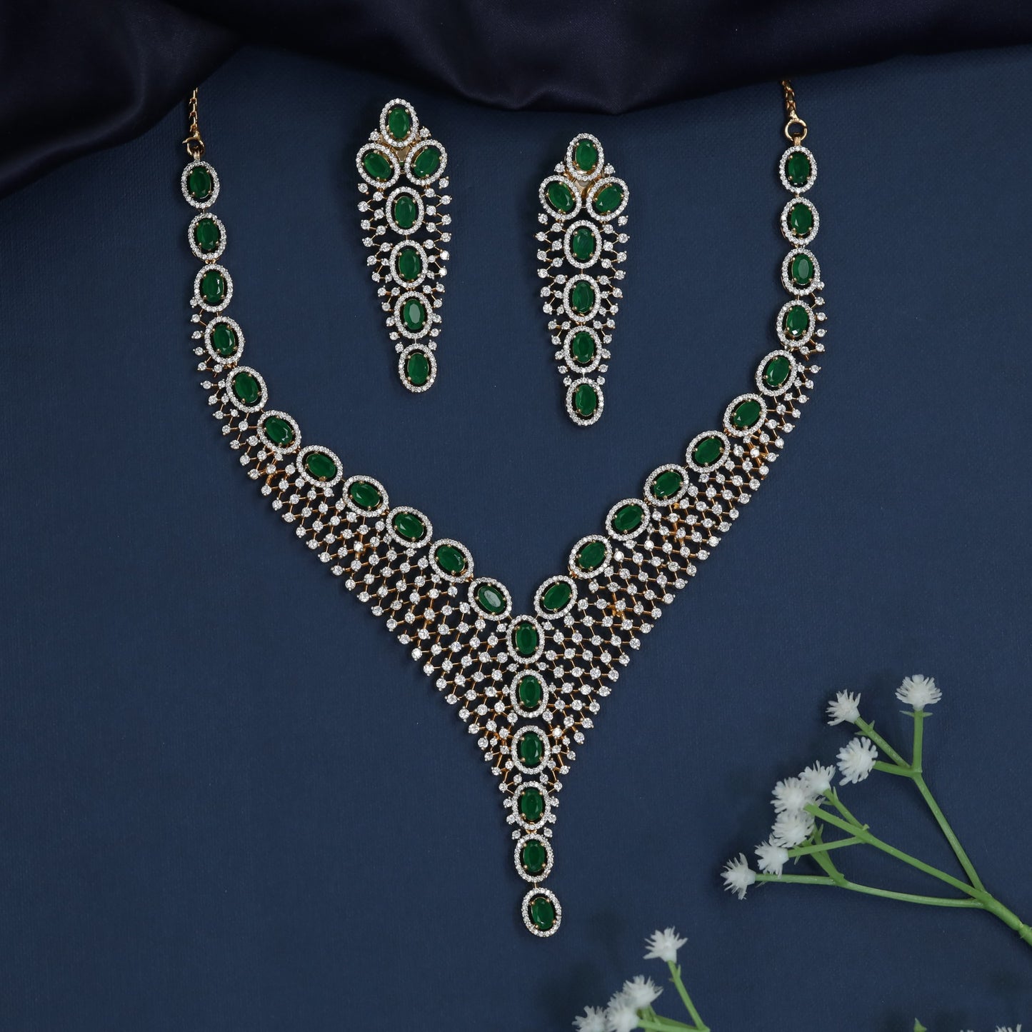 Rhodium necklace with graduated rosette arrangement and pendant drop