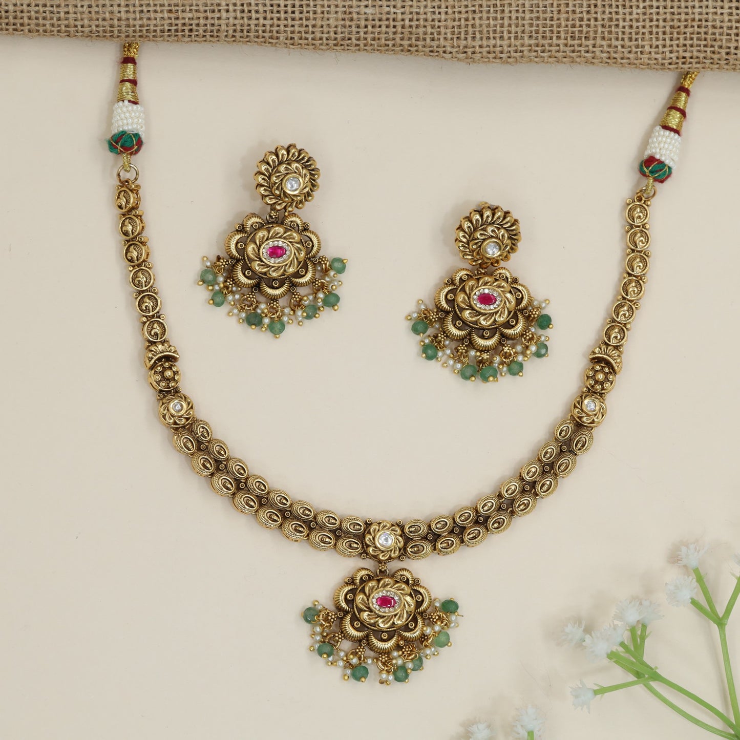 Traditional flower pendant necklace with ornate border detailing