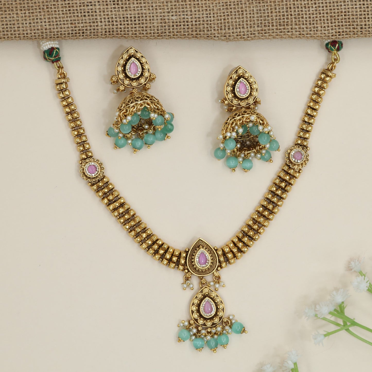 Architectural necklace with layered link construction and pendant drop