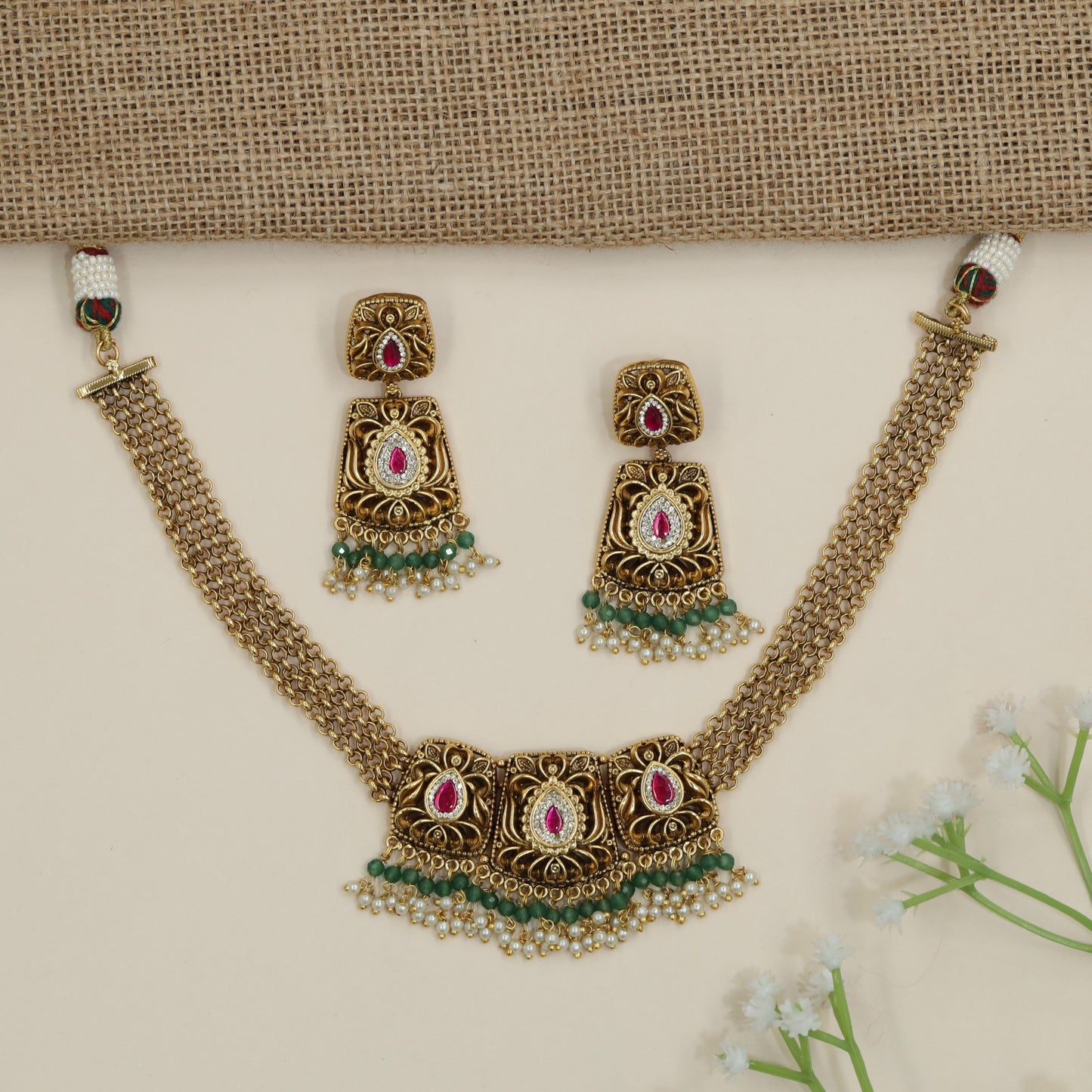 Regal scrollwork panel necklace with layered chain silhouette
