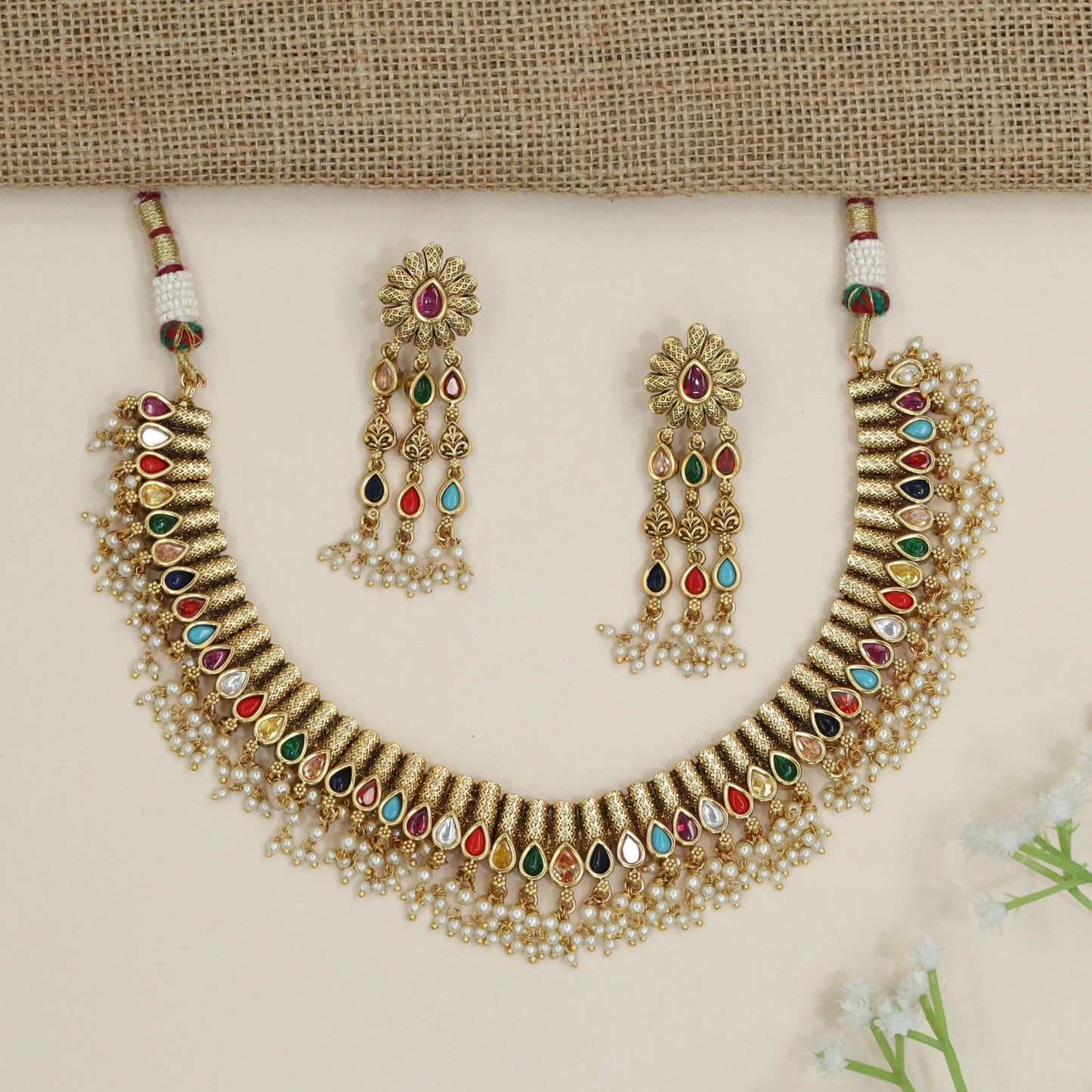 Artisan teardrop necklace with richly textured ornamental design