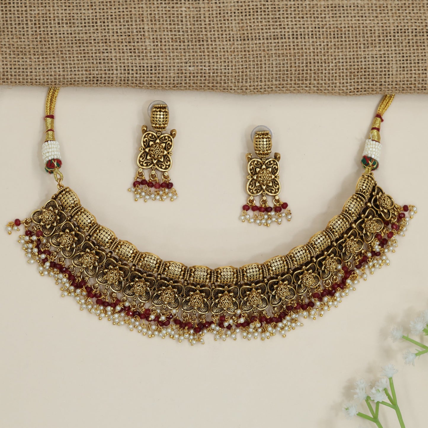Festive floral necklace with layered motif arrangement and fringe detailing