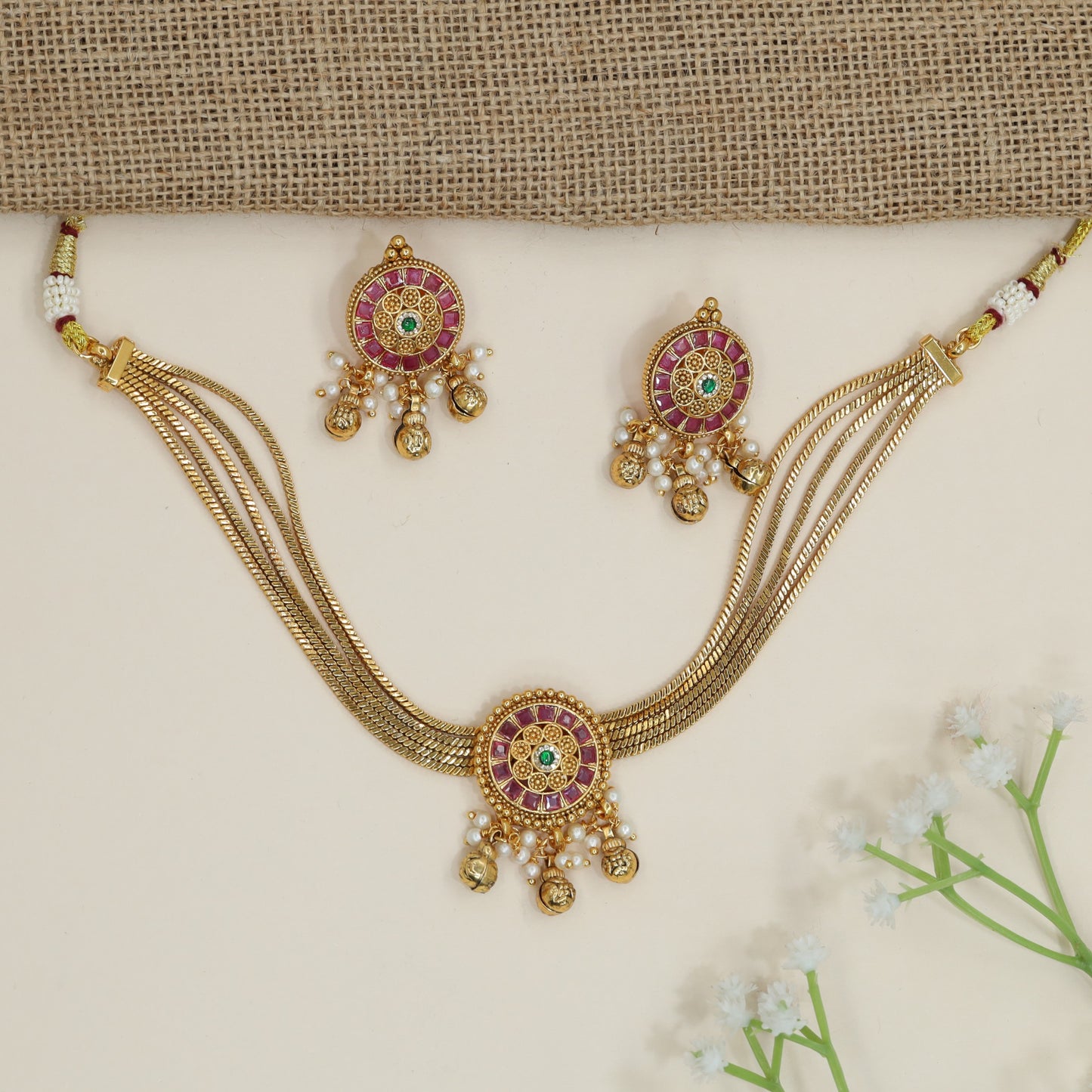 Festive disc motif choker with layered collar silhouette