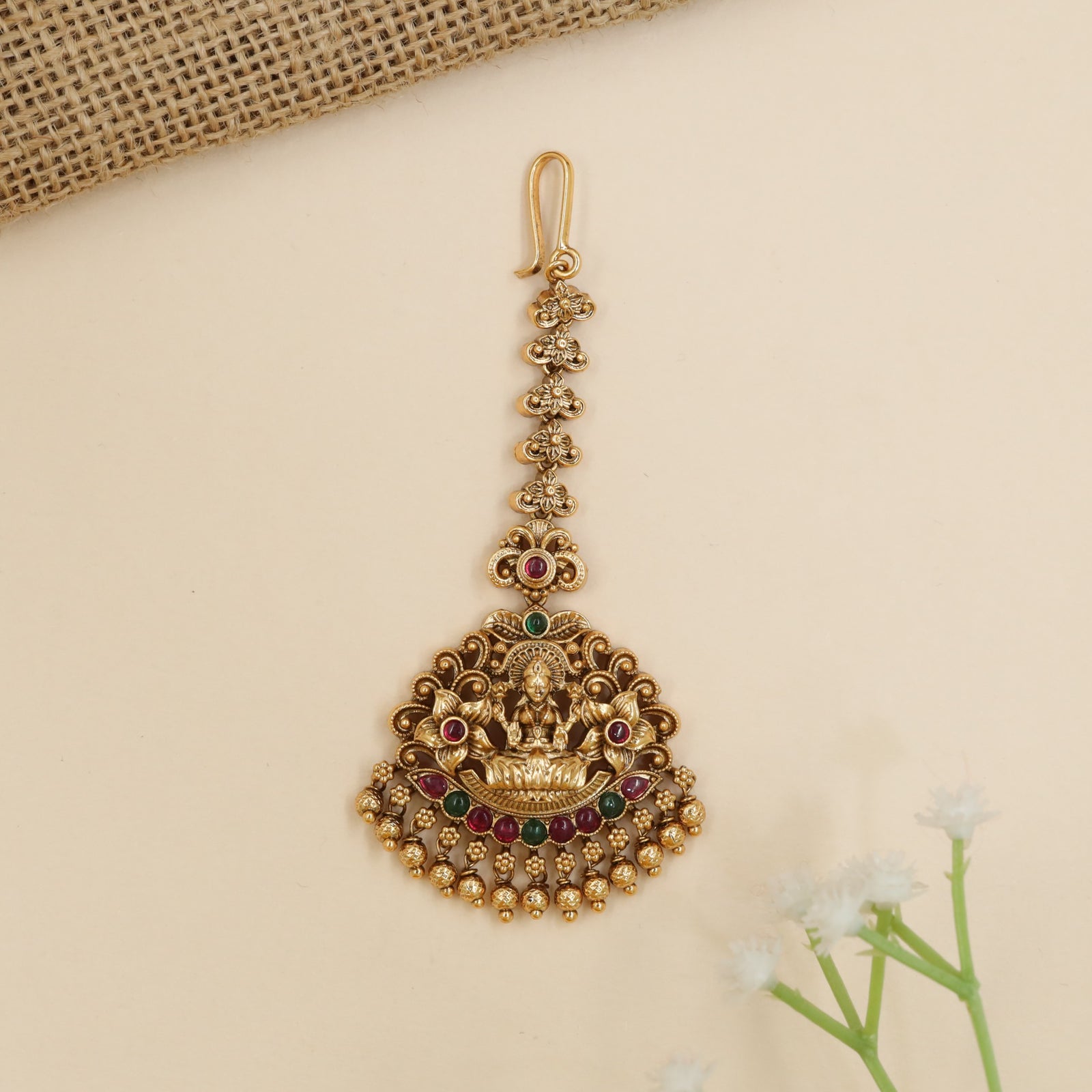 Designer temple tikka with Goddess Lakshmi centerpiece and intricate scrollwork