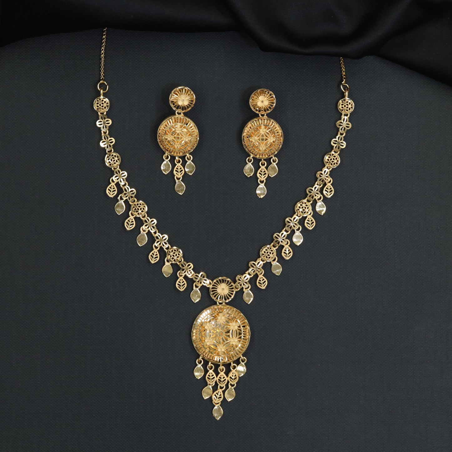 Forming Necklace with circular filigree medallion and suspended leaf droplets