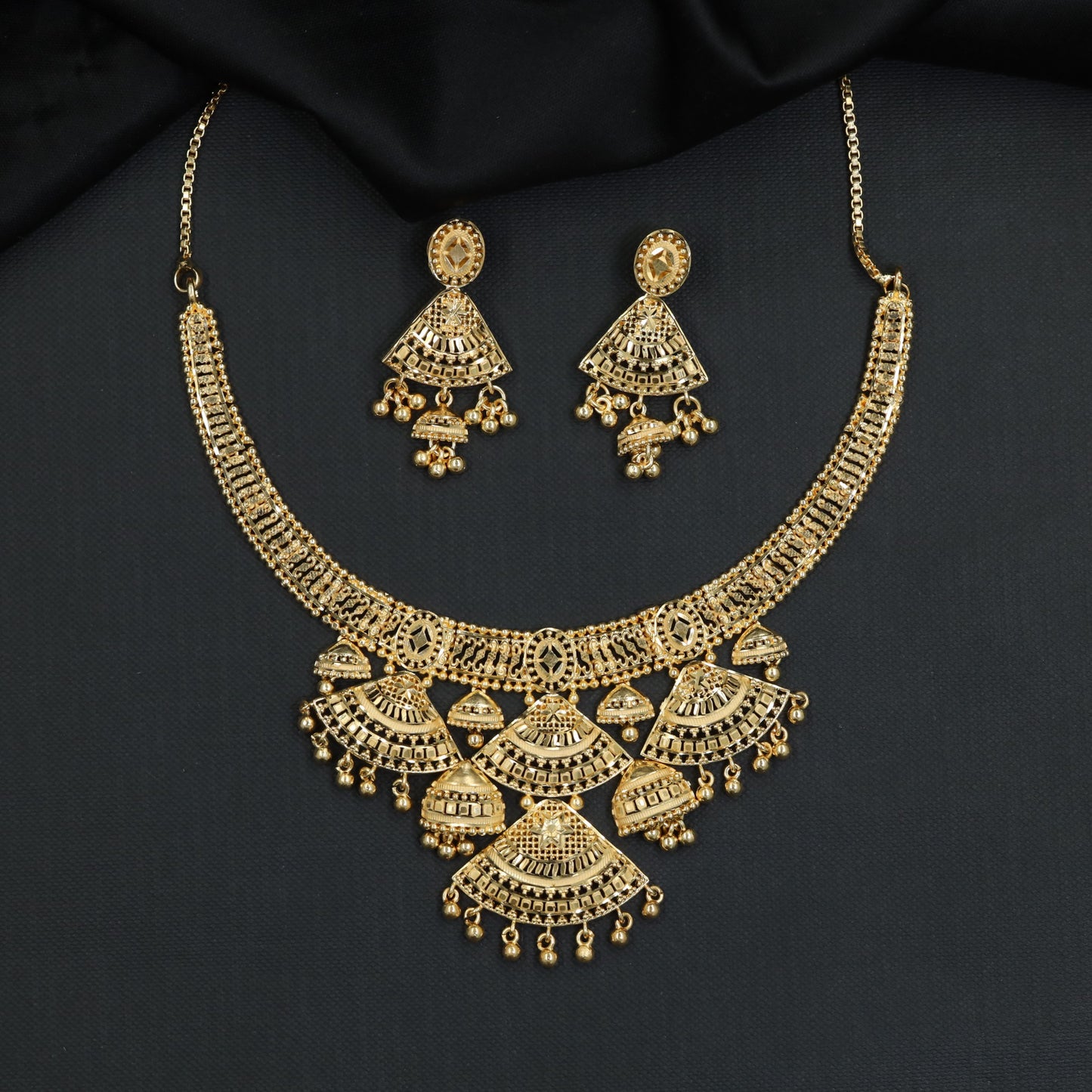 Radial Fan Elements Forming Necklace with Layered Hanging Pendants
