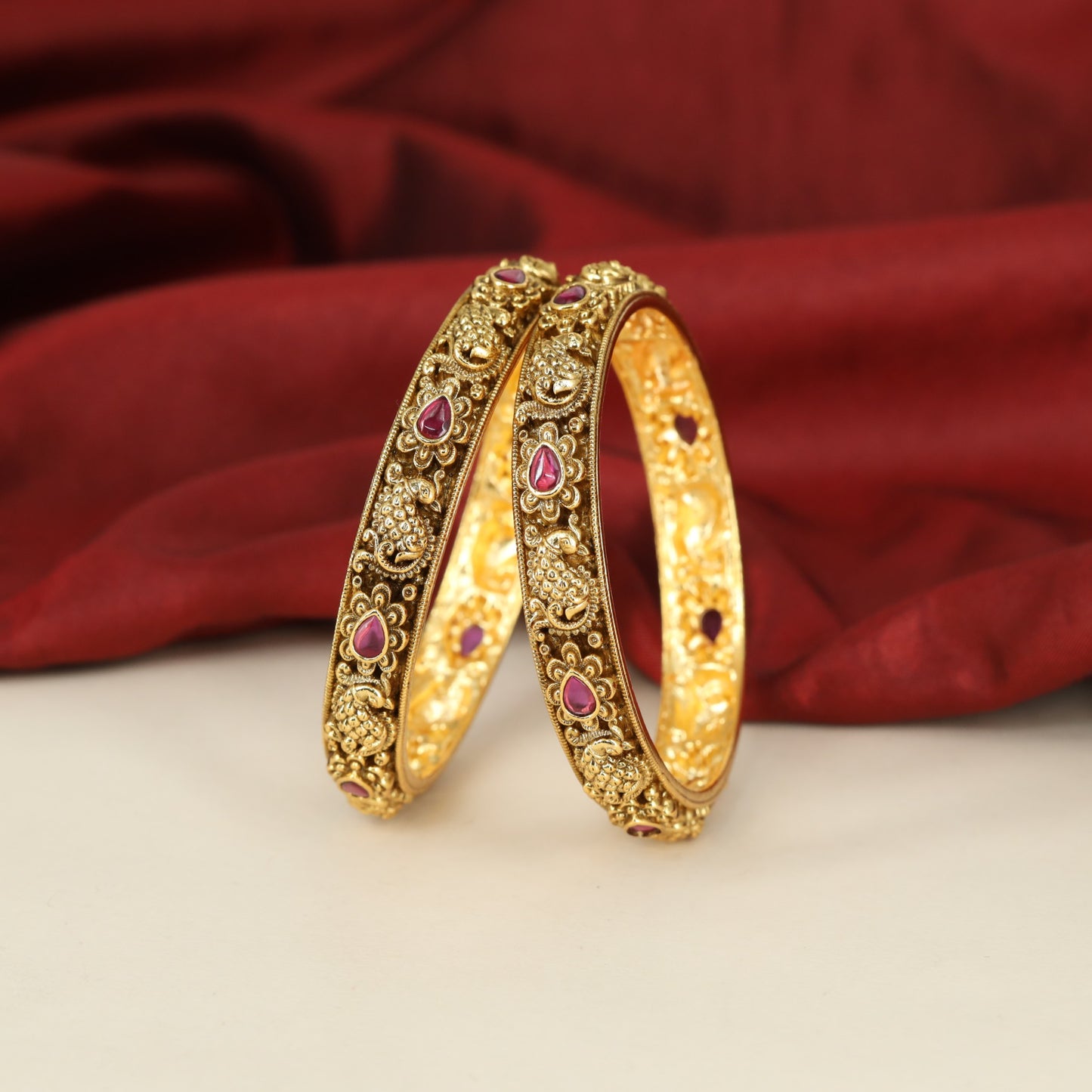 Traditional Peacock Motif Bangles with Repeated Floral Settings and Sculpted Detailing