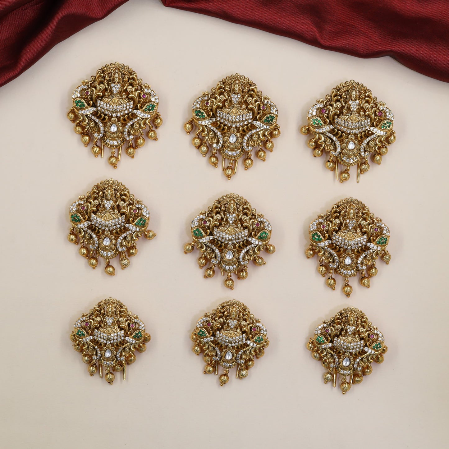 Signature Lakshmi Antique Jade Bille featuring sculpted peacocks and decorative hanging accents