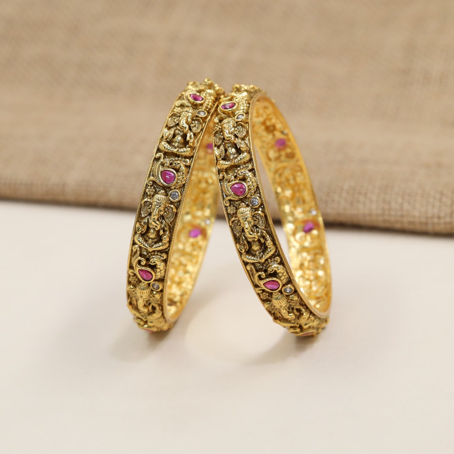 Crafted Ganesha Antique Bangles with sculpted figures and ornamental framing