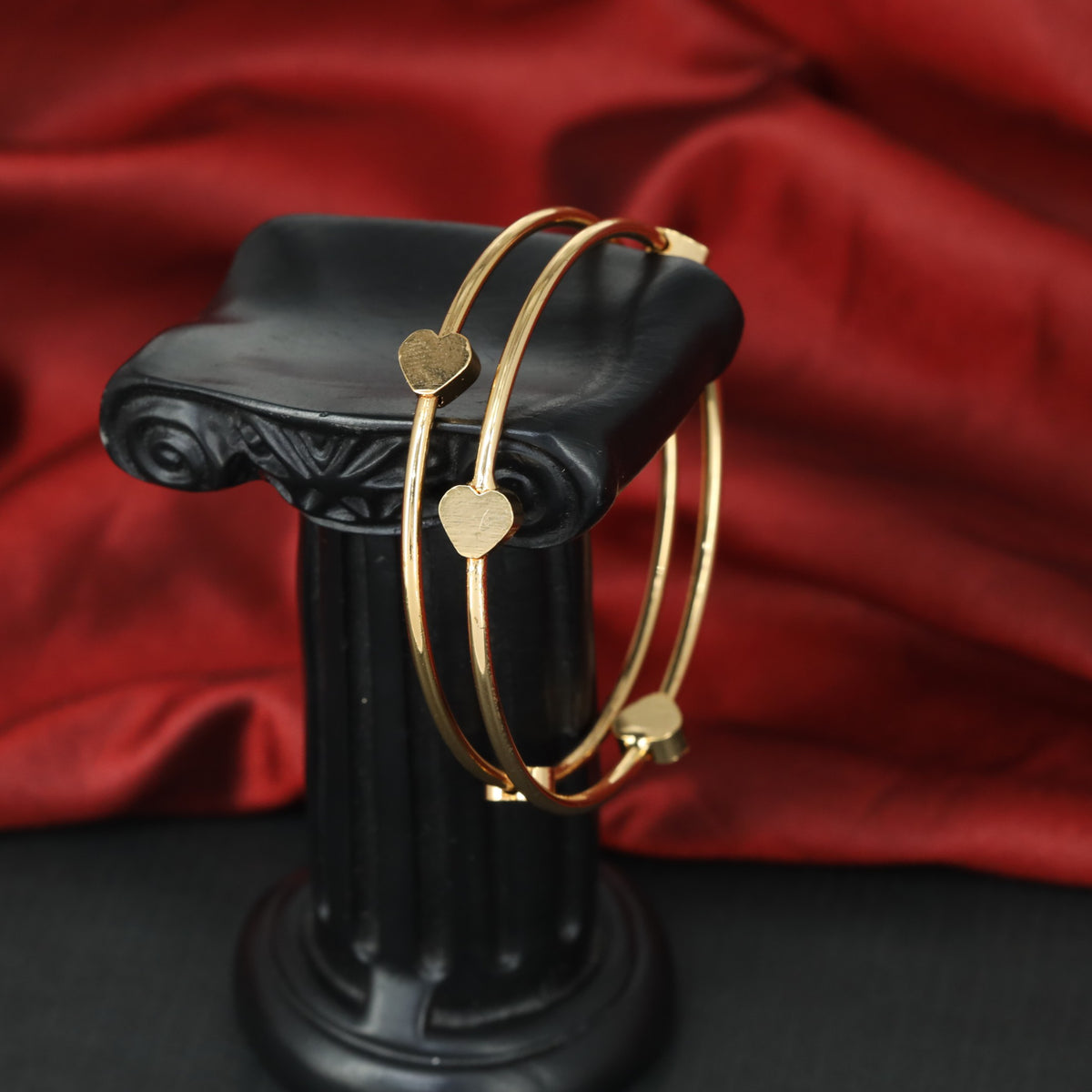 Classic gold bangles with charming ornamental hearts