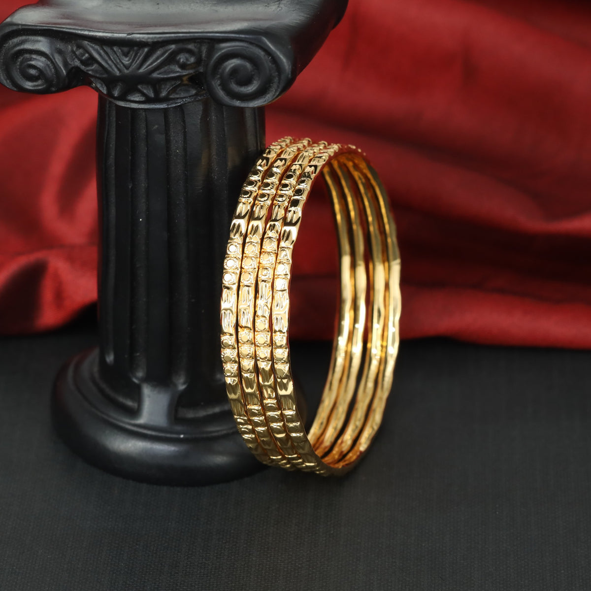 Premium gold bangles with intricate surface detailing