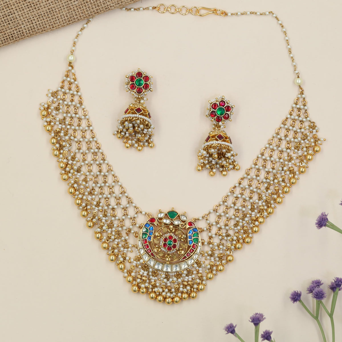 Signature jadau necklace with a detailed medallion pendant and cascading beads
