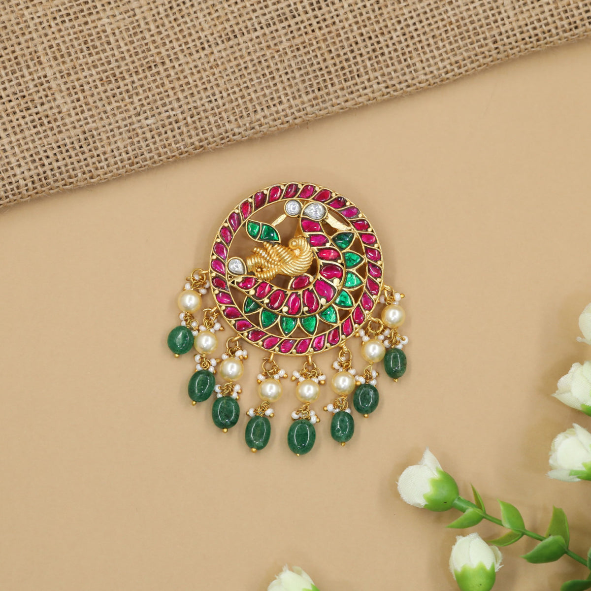 Grand jadau pendant featuring an ornate peacock centre and decorative bead fringe
