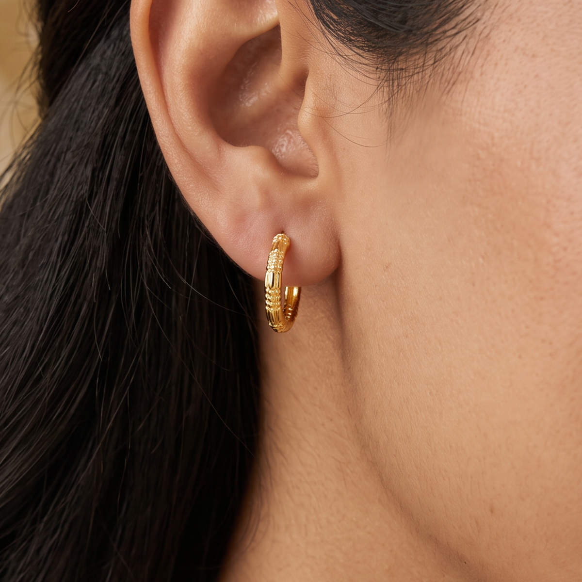 A Structured Rounded Hoop With Gold Polish Bali and Fine Linework