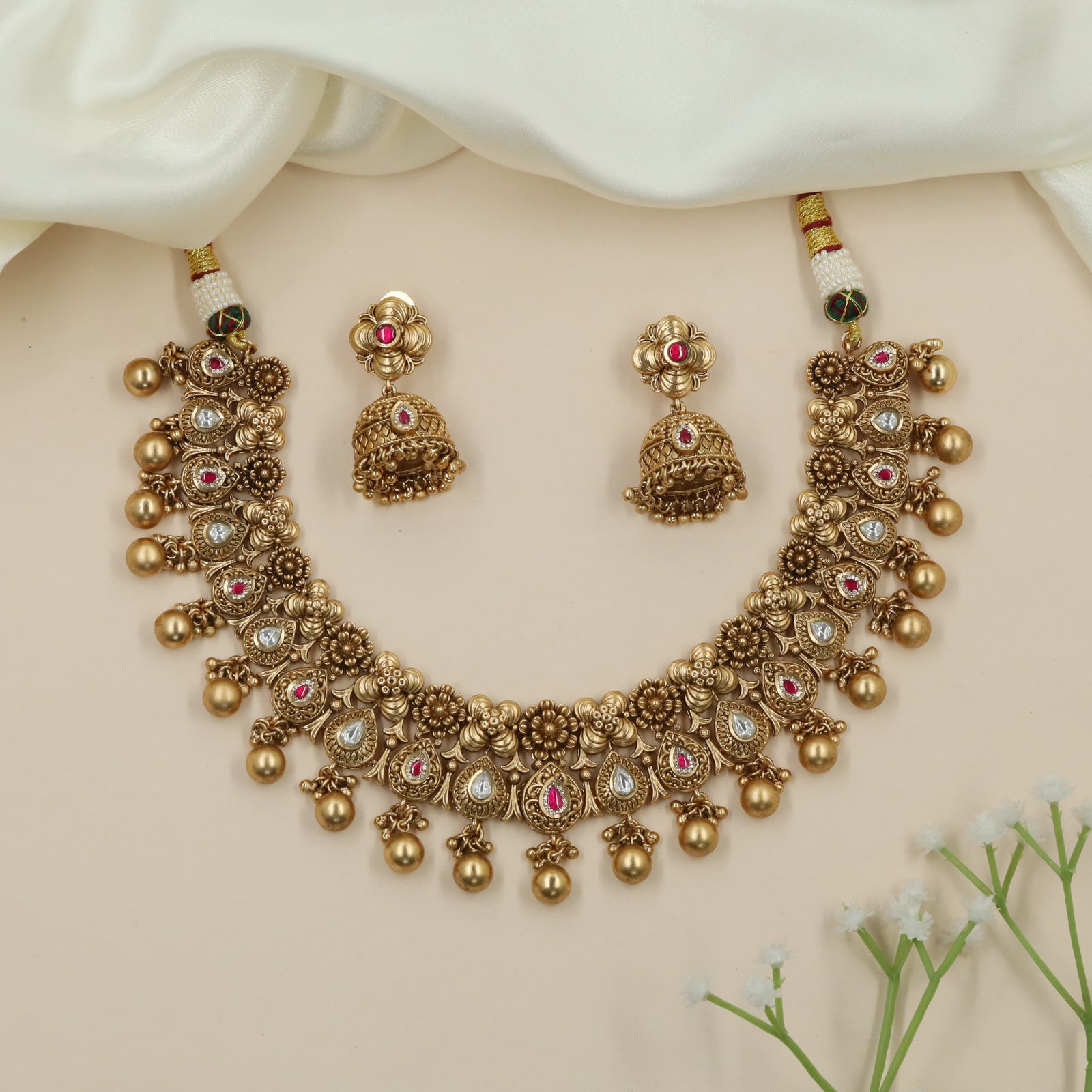 Dewline Floral Kundan Necklace with Hanging Ball Tassels