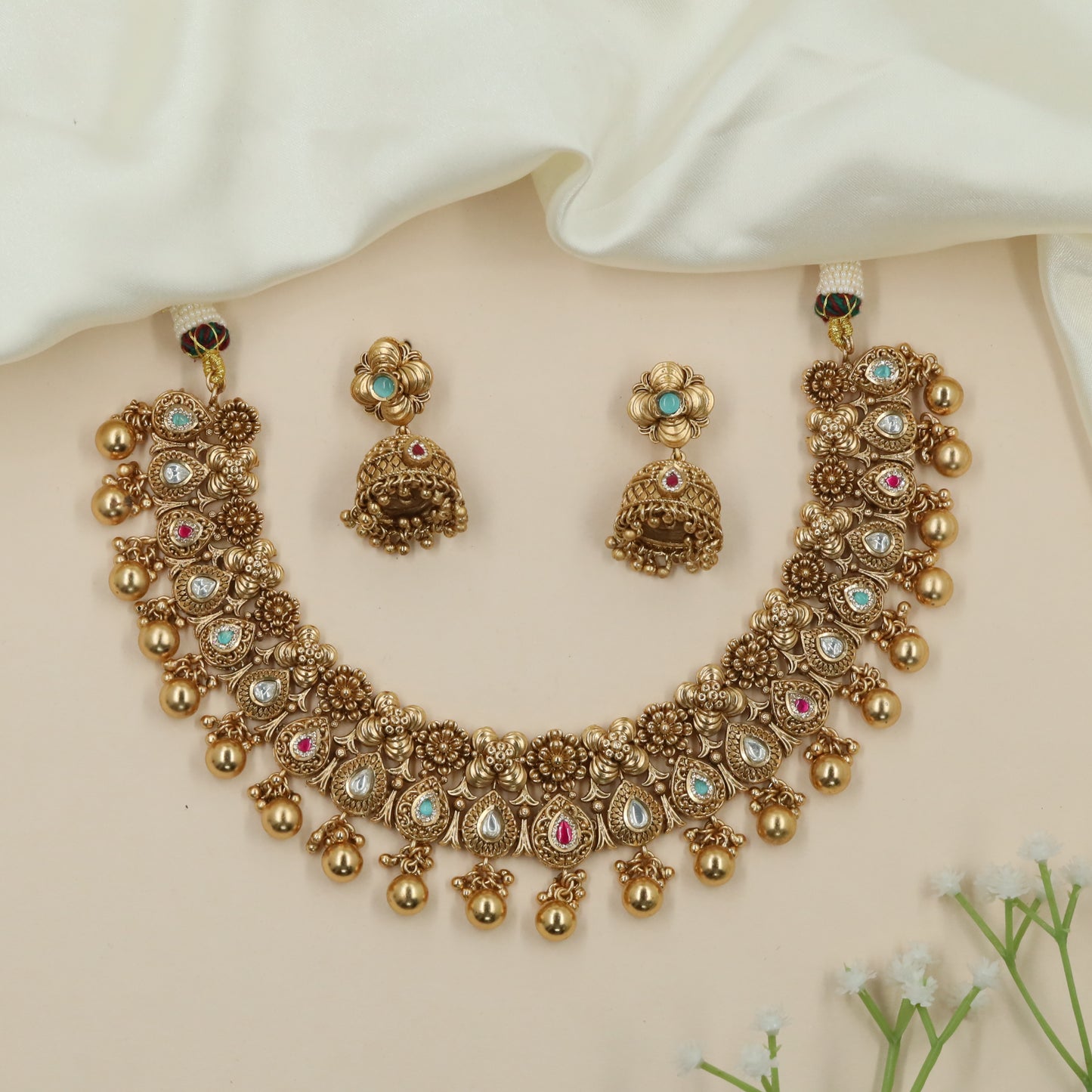 Dewline Floral Kundan Necklace with Hanging Ball Tassels