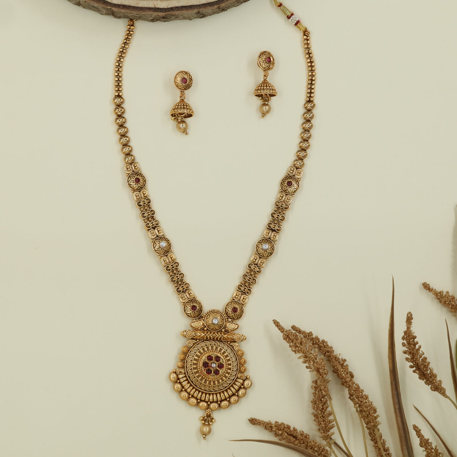Granulated bead long haara with textured links and ornate medallion pendant with hanging drop