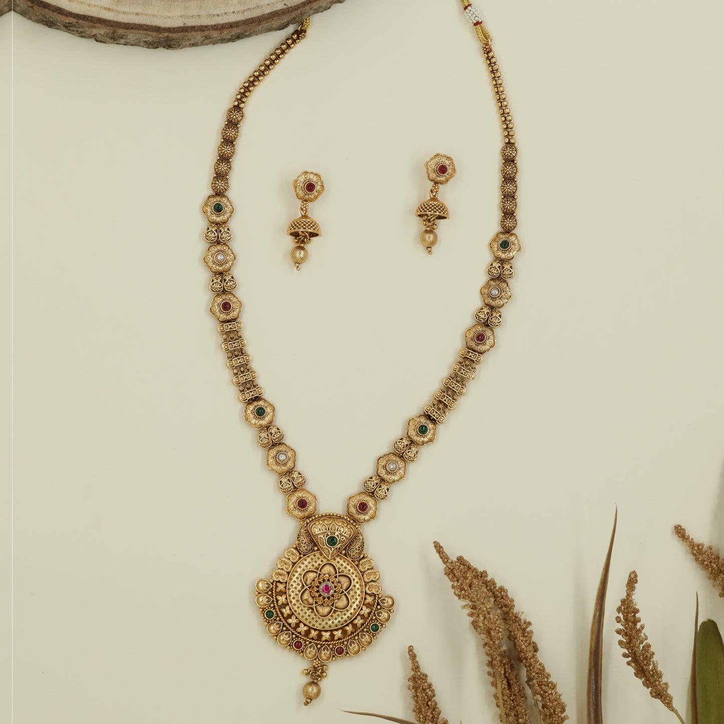 Floral link long haara with repeating disc sections and broad medallion pendant with bead hanging