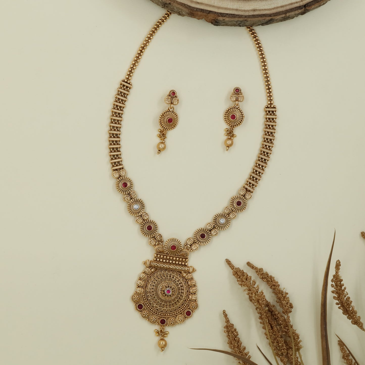 Floral disc antique long haara with patterned panels and layered medallion drop