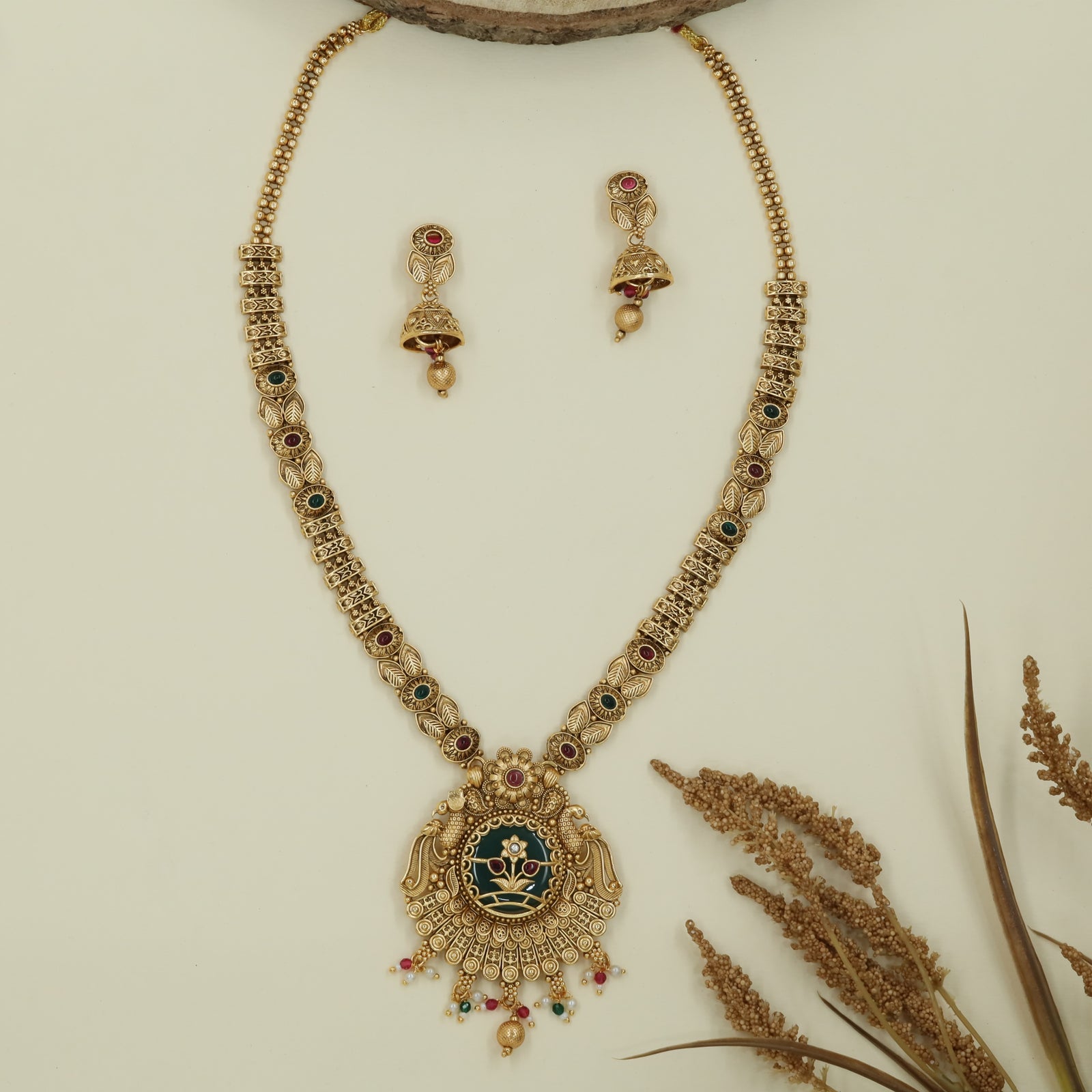 Honeycomb link long haara with patterned connectors and peacock pendant with drop fringe