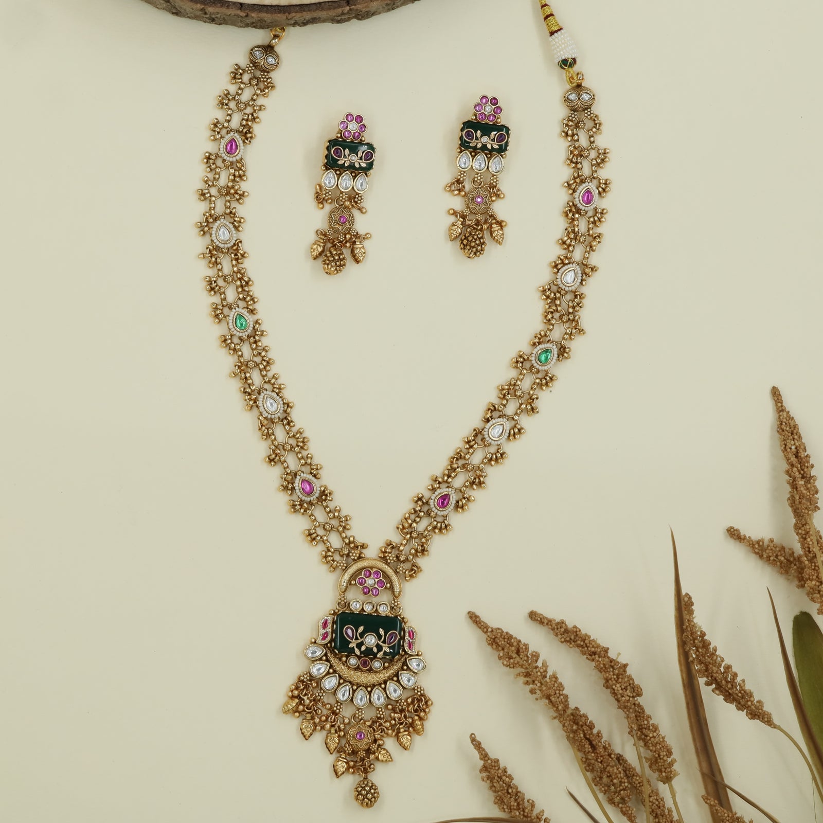 Dual strand kundan long haara with clustered bead chains and decorative enamel pendant with dangles