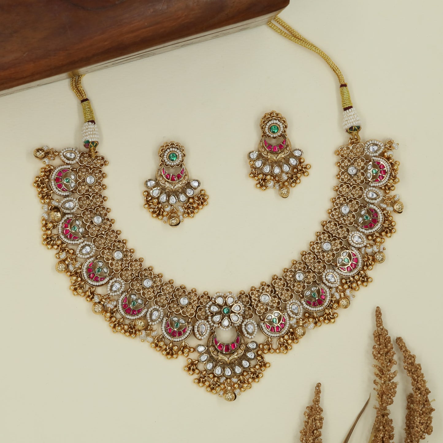 Segmented arc kundan necklace with oval highlights and layered drop edge