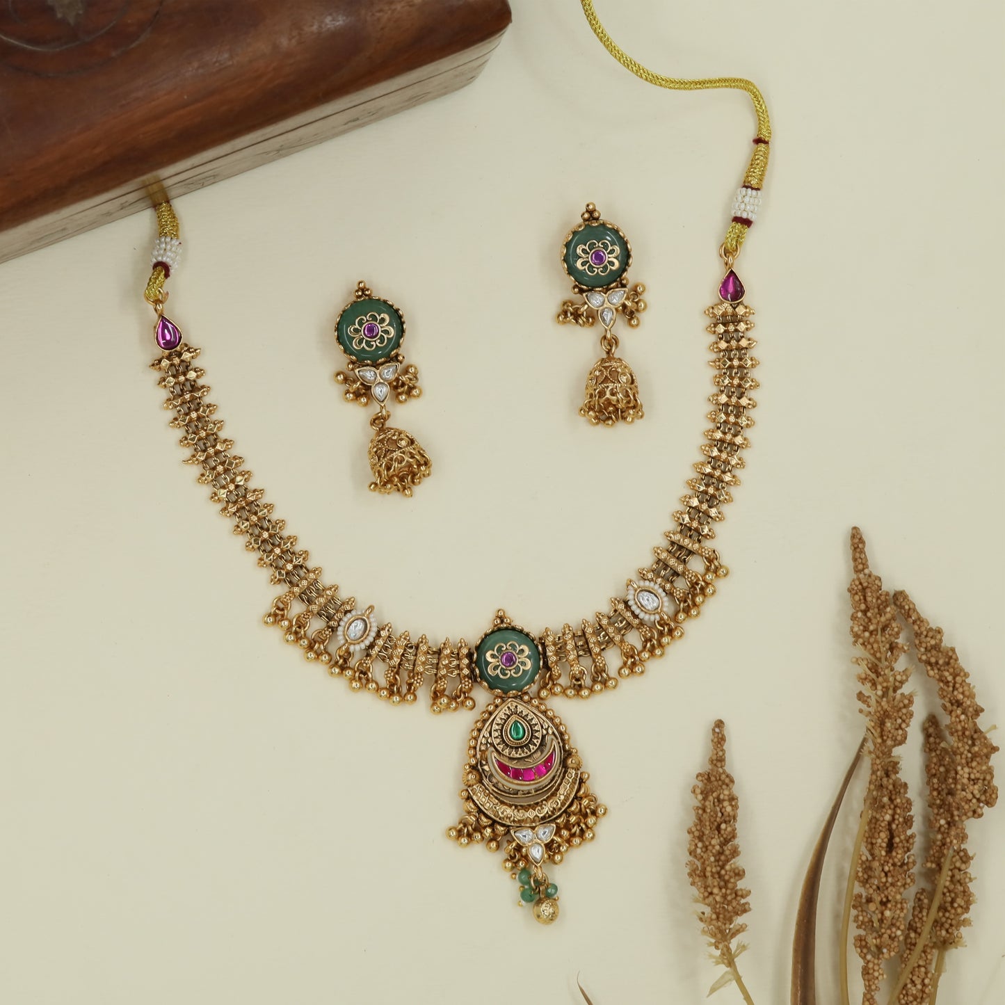Central disc kundan necklace with drop chain fringe and layered pendant unit