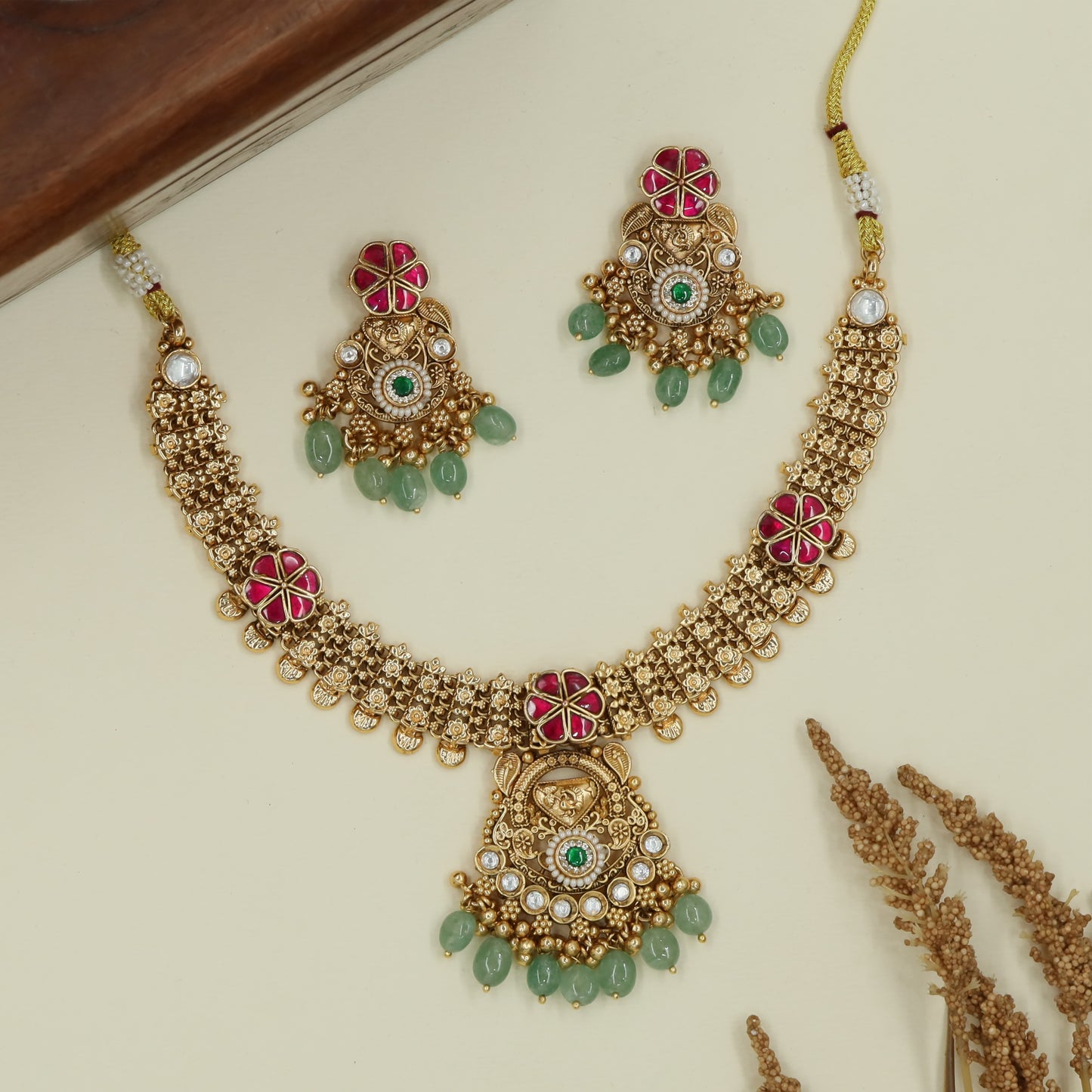 Blossom disc kundan necklace with repeating flower panels and hanging drops