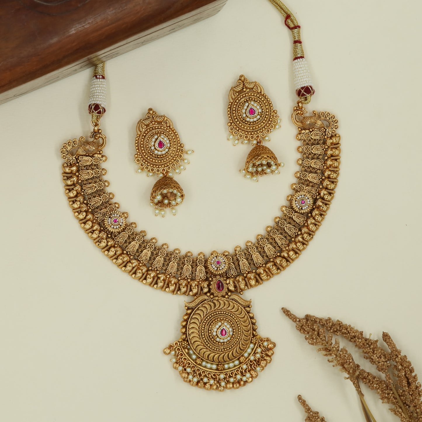 Curved temple panel kundan necklace with sculpted peacock side elements and large circular pendant