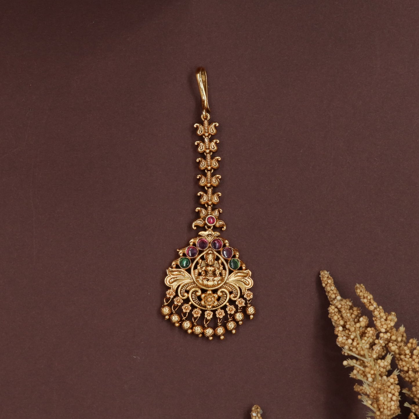 Decorative lakshmi tikka with scroll connectors and fringe bead edging