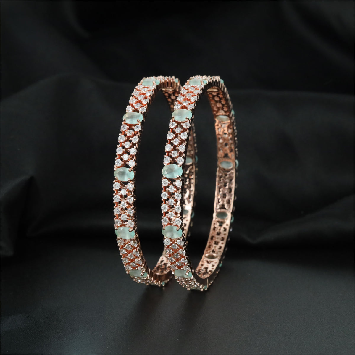 Rose gold bangles with alternating stone-set rows and oval accents