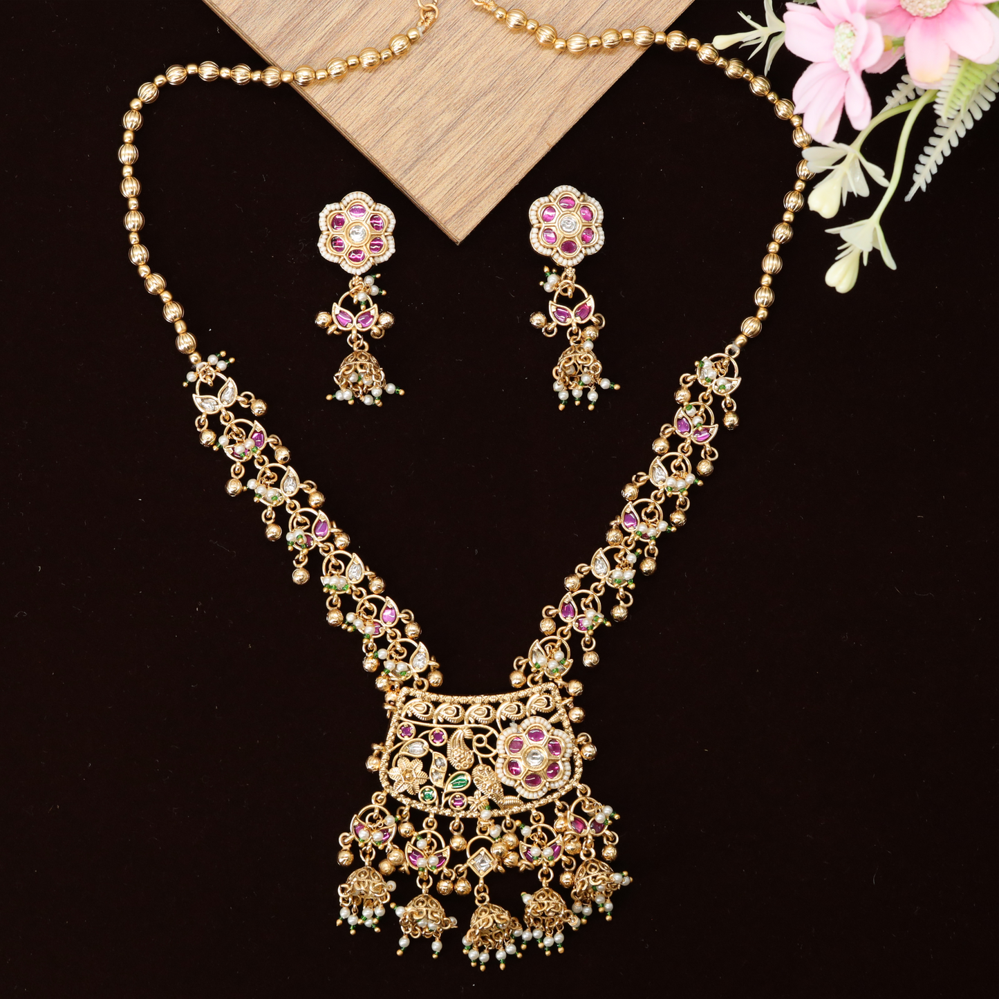 Designer Long Haara with Intricate Filigree Pendant and Dangling Bell Details