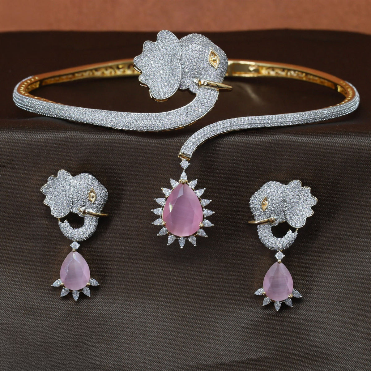 Gold polish necklace featuring an elephant head and curved cuff design