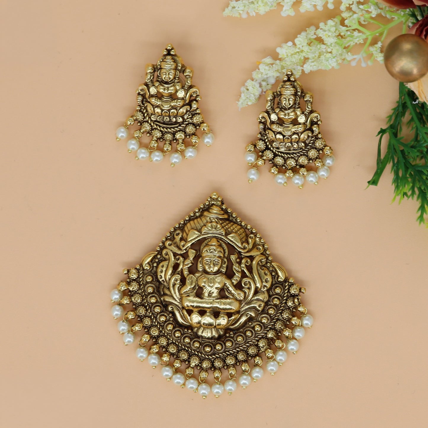 Antique Lakshmi pendant set with richly detailed goddess carving and hanging pearls