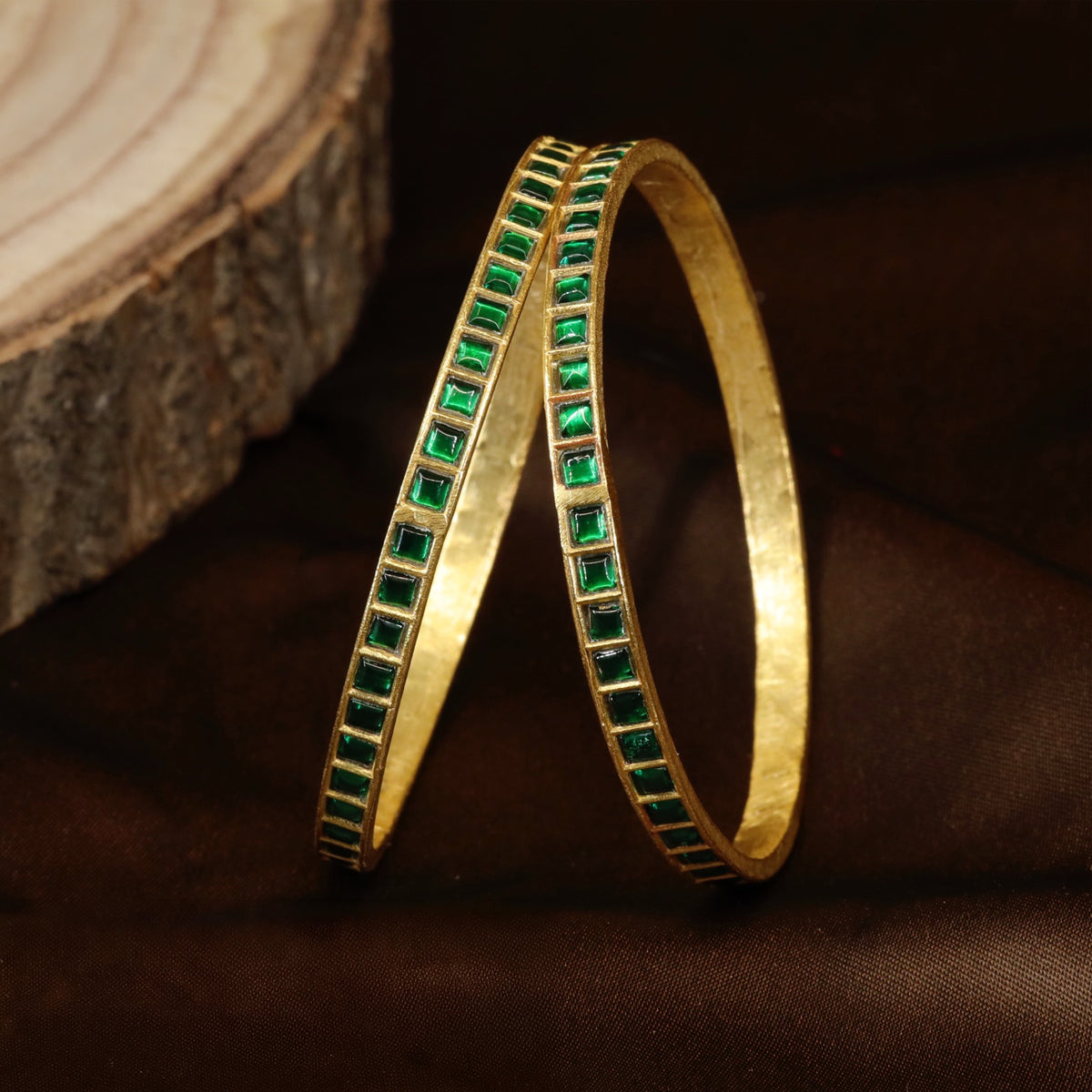 Jadau bangles with refined square stone detailing and a sleek traditional finish