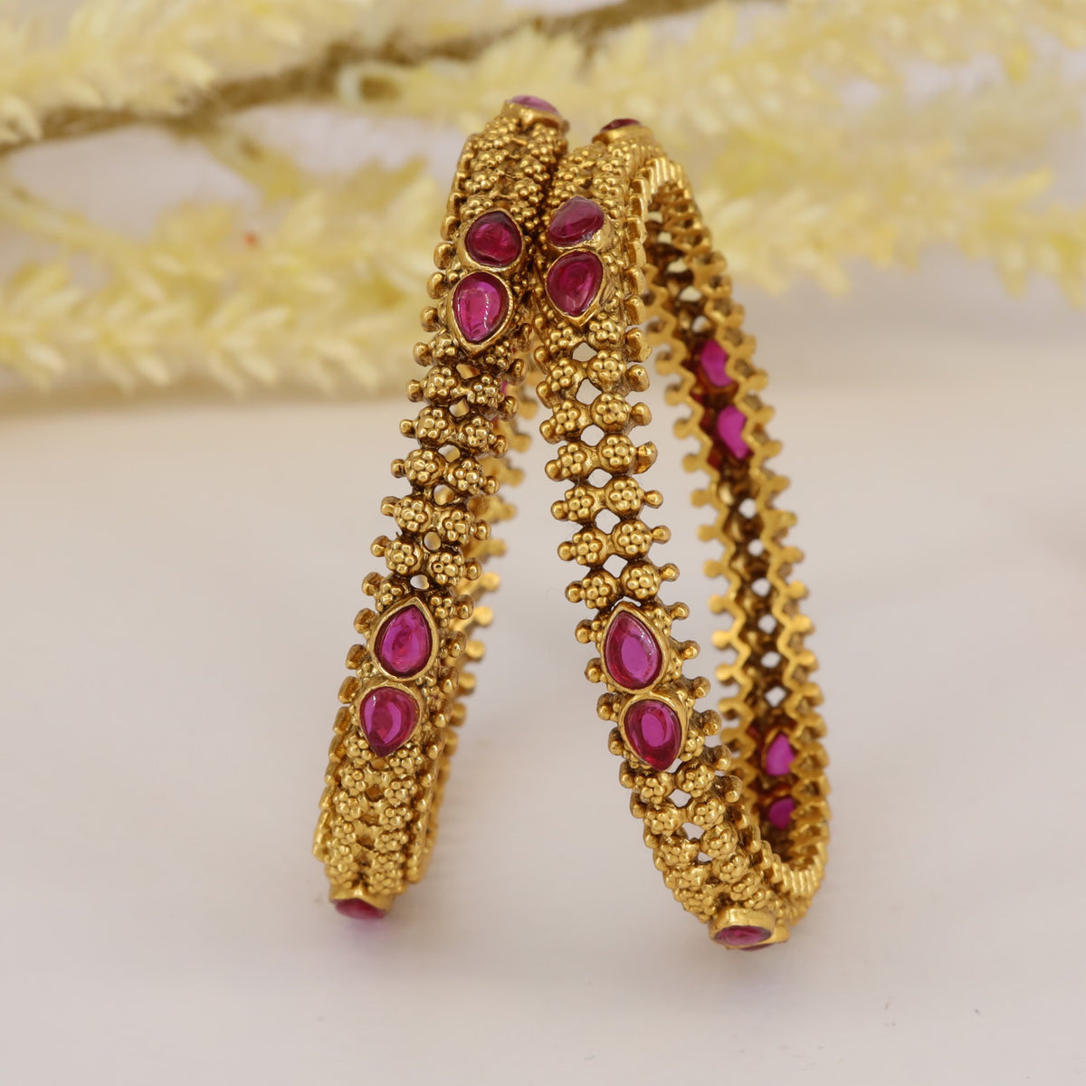 Antique bangles with intricate floral beadwork and teardrop detailing