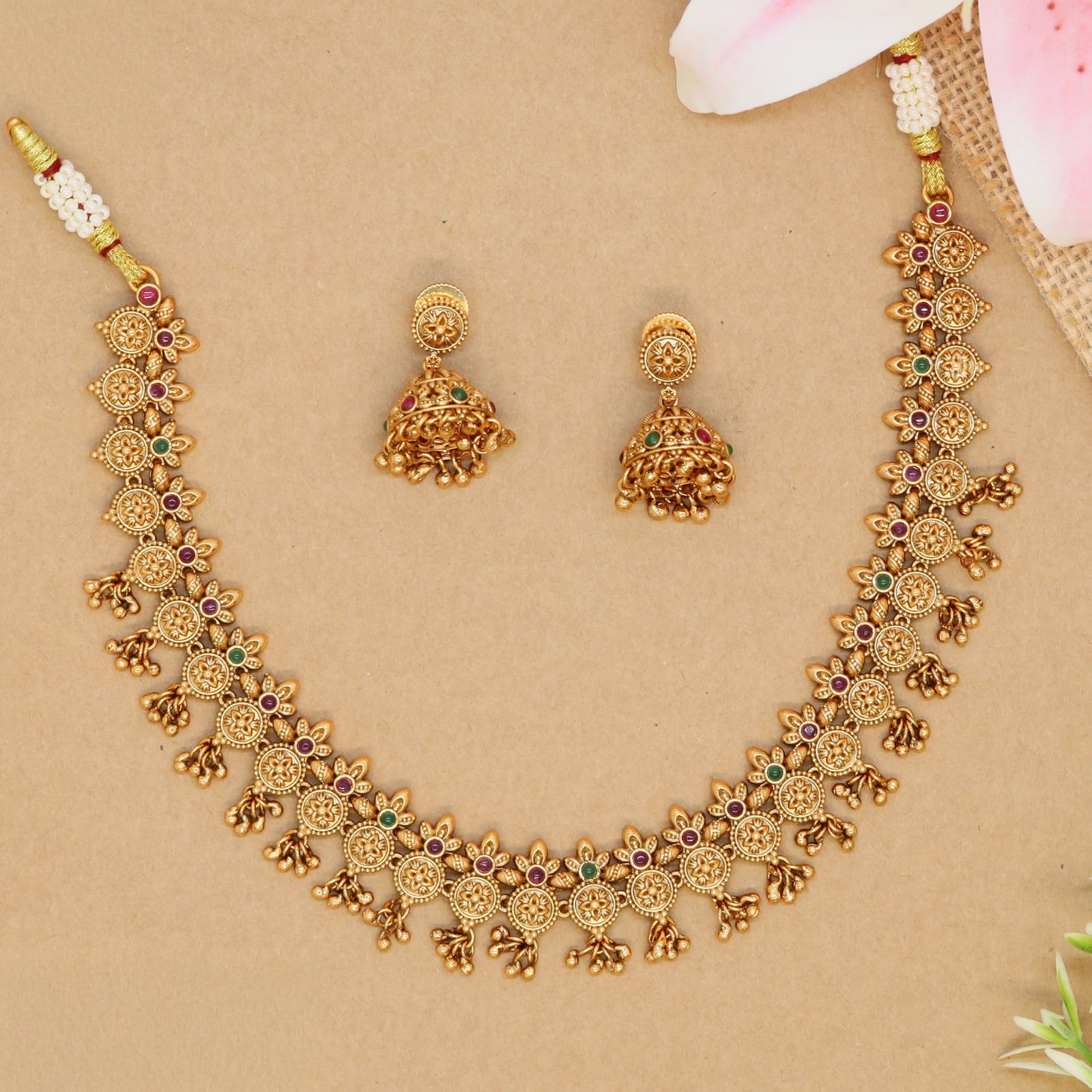 Floral link necklace with repeating round panels and small drop hangings