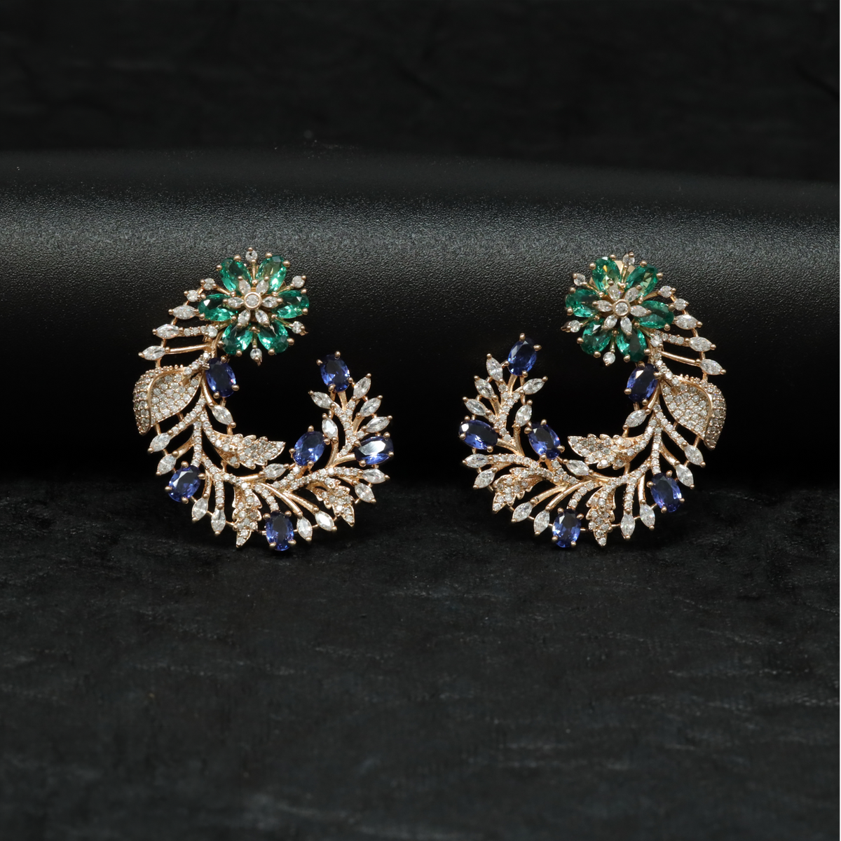 Rose gold floral studs with a distinctive curved profile